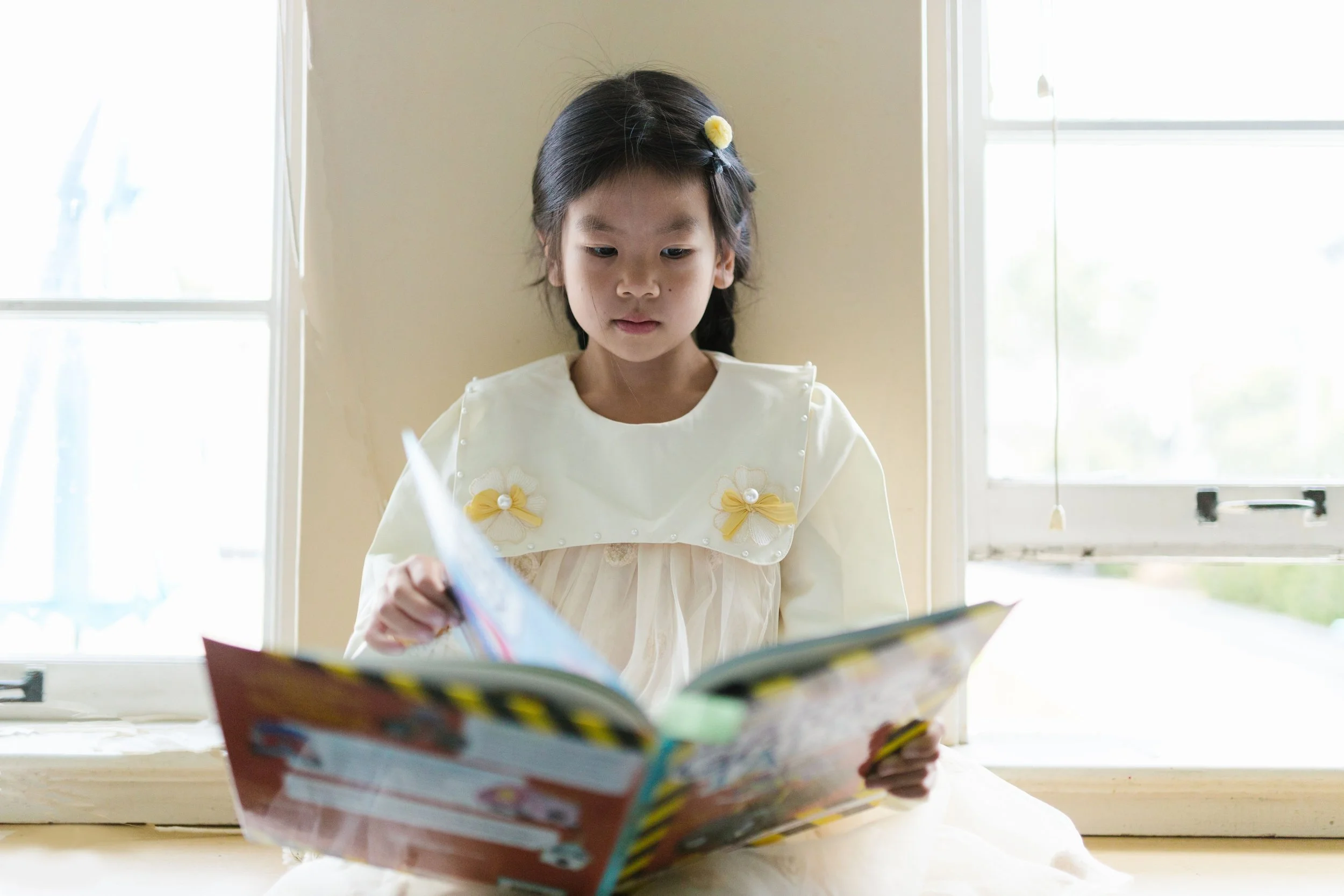 Student engaging with personalized reading materials in a bright learning environment.