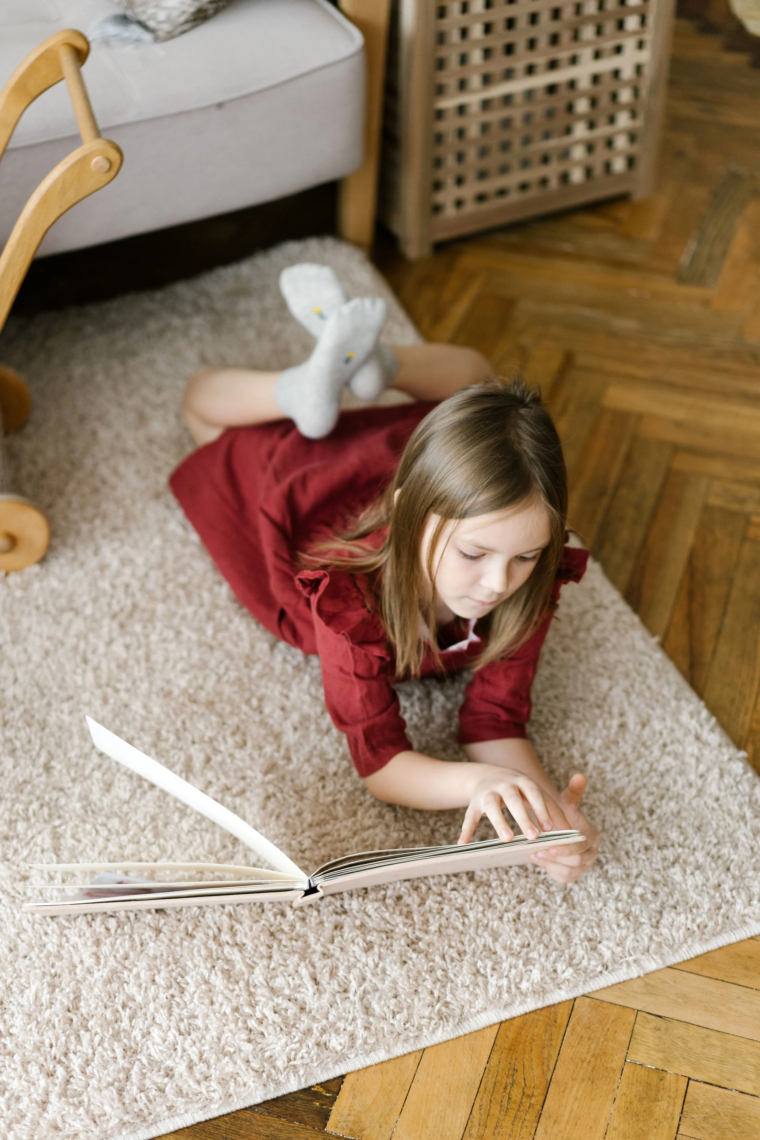 Young student practicing independent reading in a comfortable learning space.