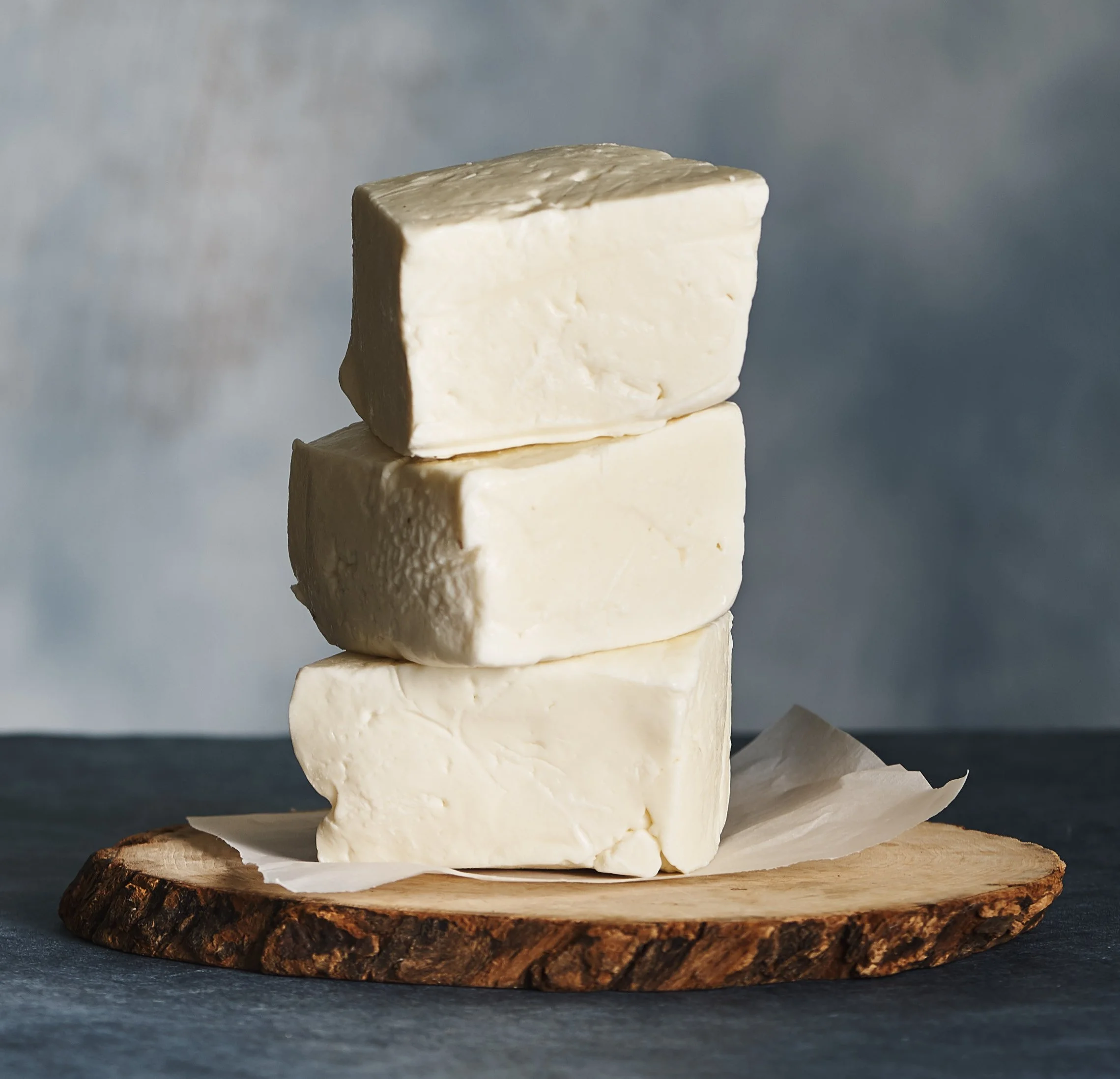 Stack of three slices of jibneh on a wood board