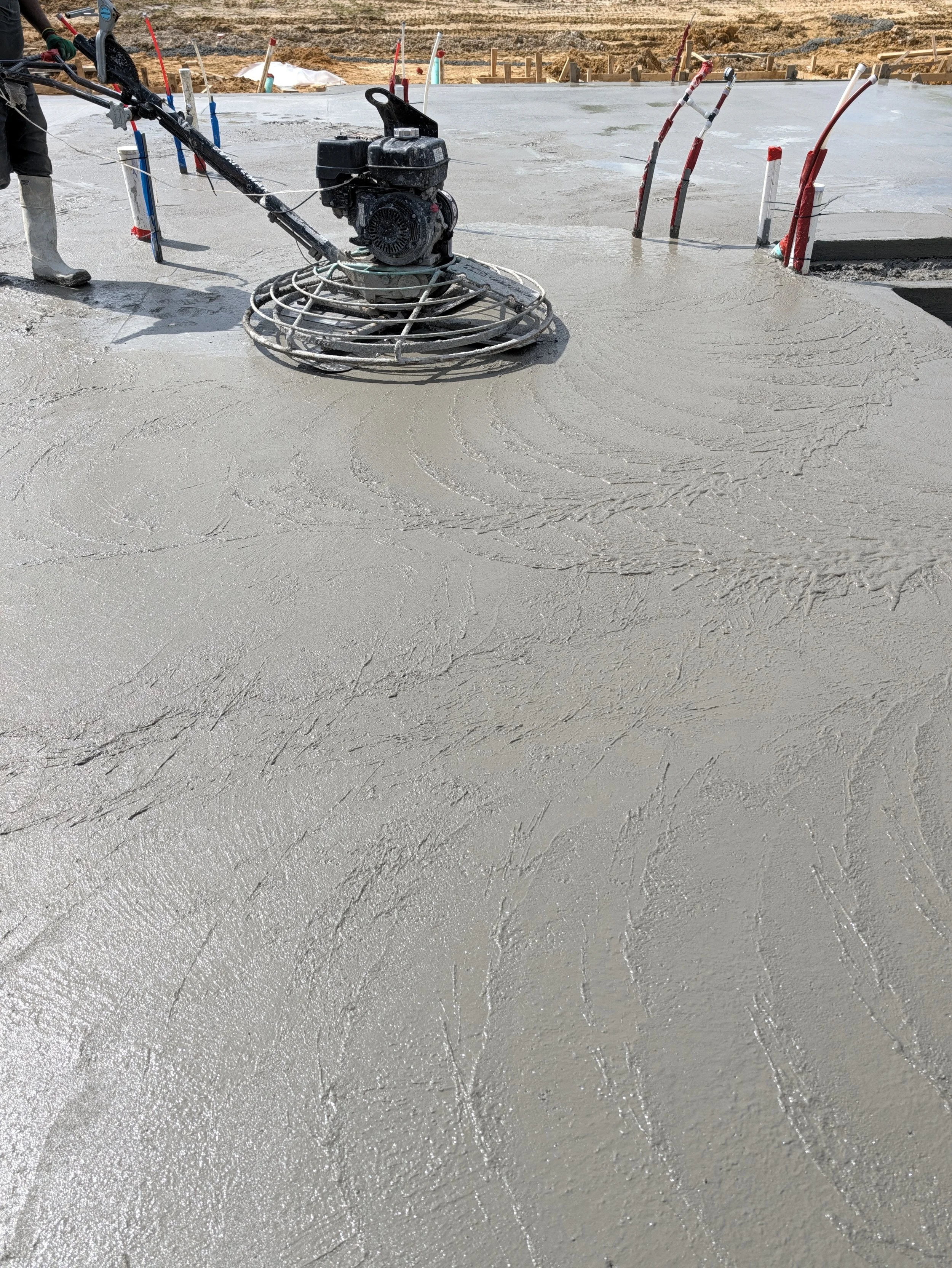 Power trowel finishing a smooth concrete slab