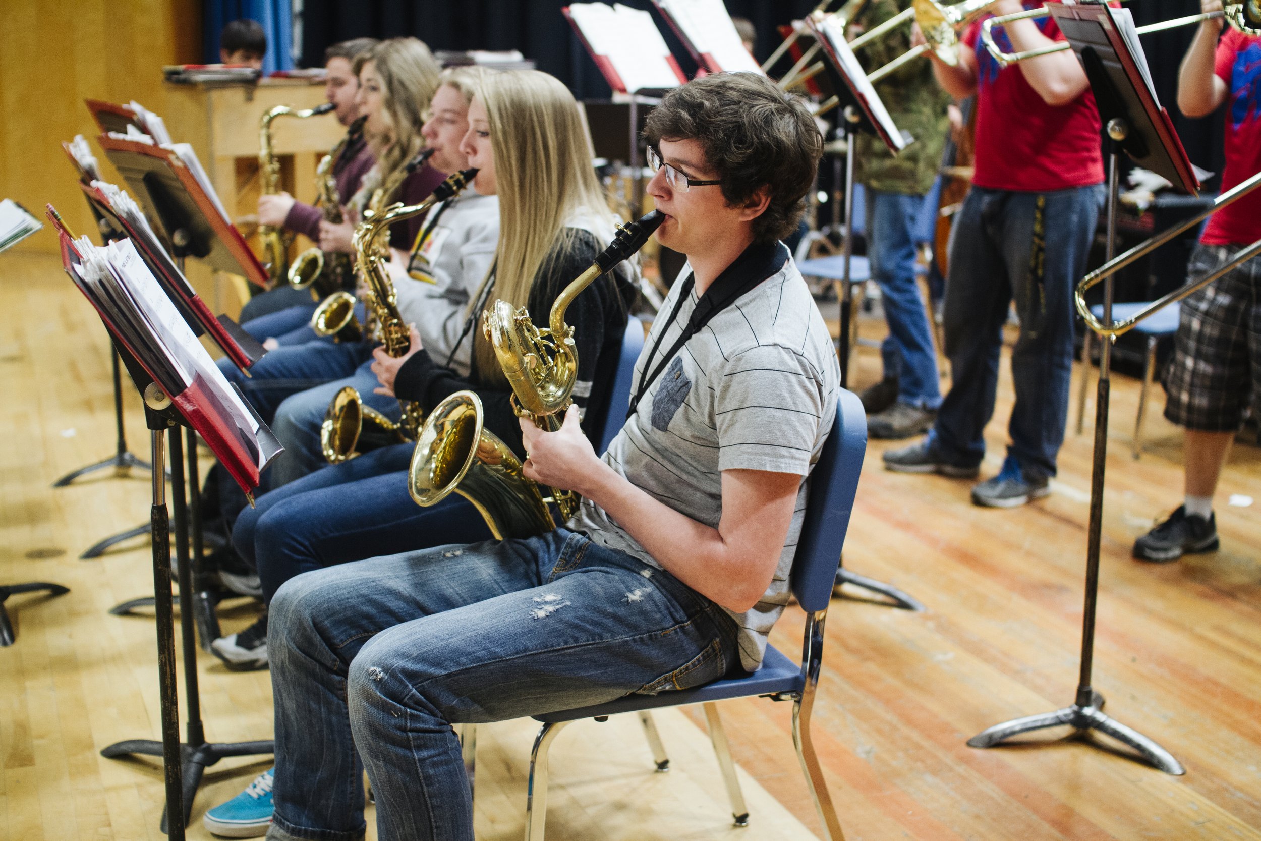 Columbia Falls Junior High Students playing saxophones in a band practice.