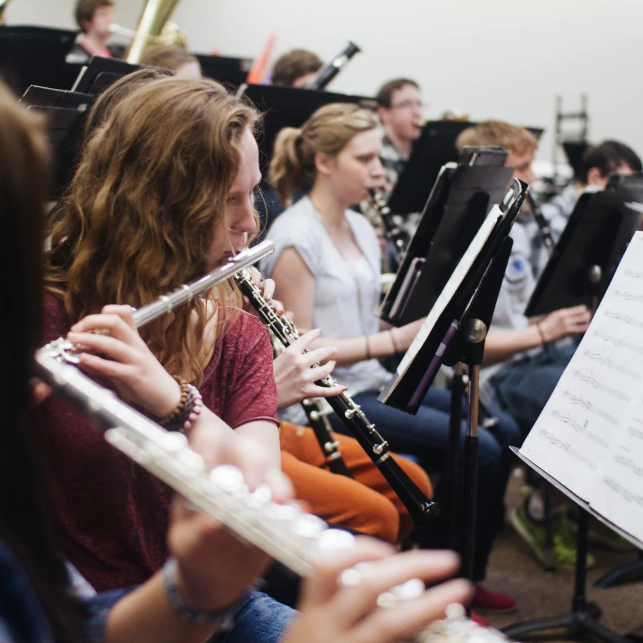 Group of Columbia Falls High School students playing flutes during band rehearsal in a classroom