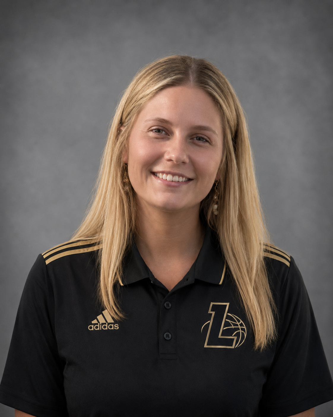 A young woman with long blonde hair smiling, wearing a black Adidas sports polo with gold accents and a logo featuring the letter 'L' and a basketball, against a gray background.