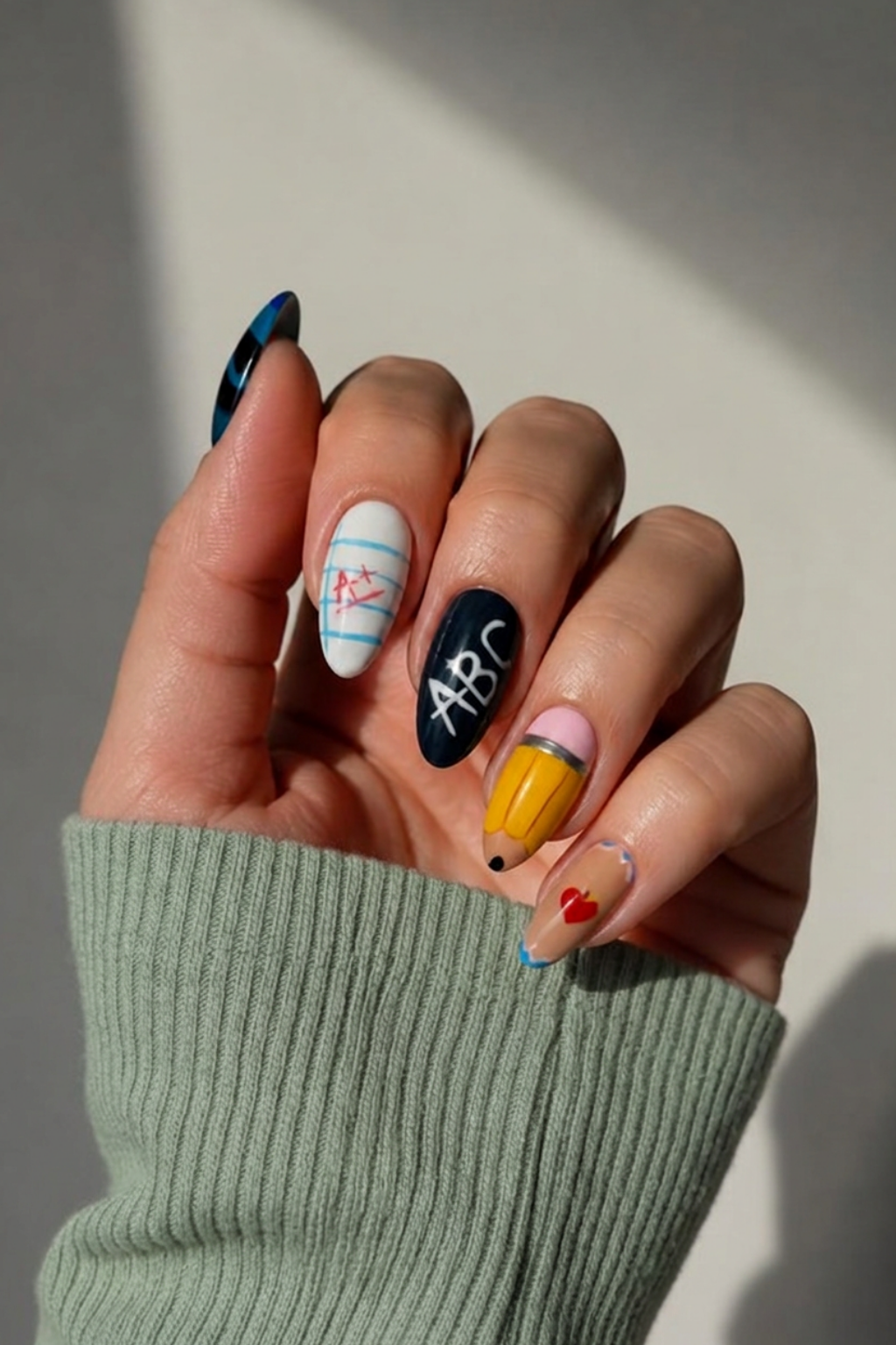 Back-to-school nail hand green shirt.png