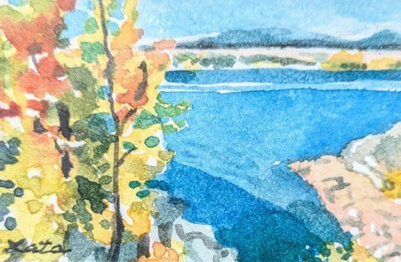 A watercolor painting of a lakeside scene with a tree in the foreground, water, and distant hills.