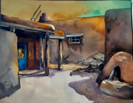 Watercolor painting of a rustic outdoor scene with a weathered building, a small window, a chimney, a blue door, and an old well or similar structure in the foreground, under a colorful sky.