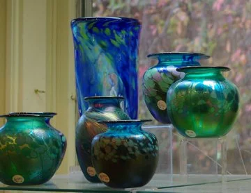 Colorful hand-blown glass vases on a window ledge