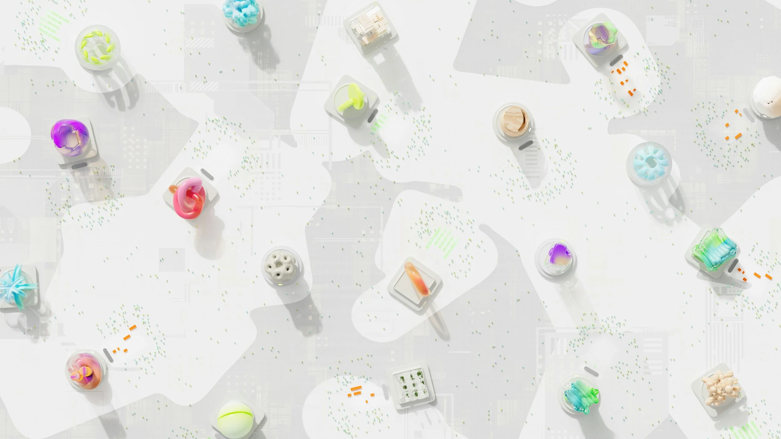An aerial view of a miniature model of a city with colorful abstract structures and green trees, set on a light background with streets and pathways.
