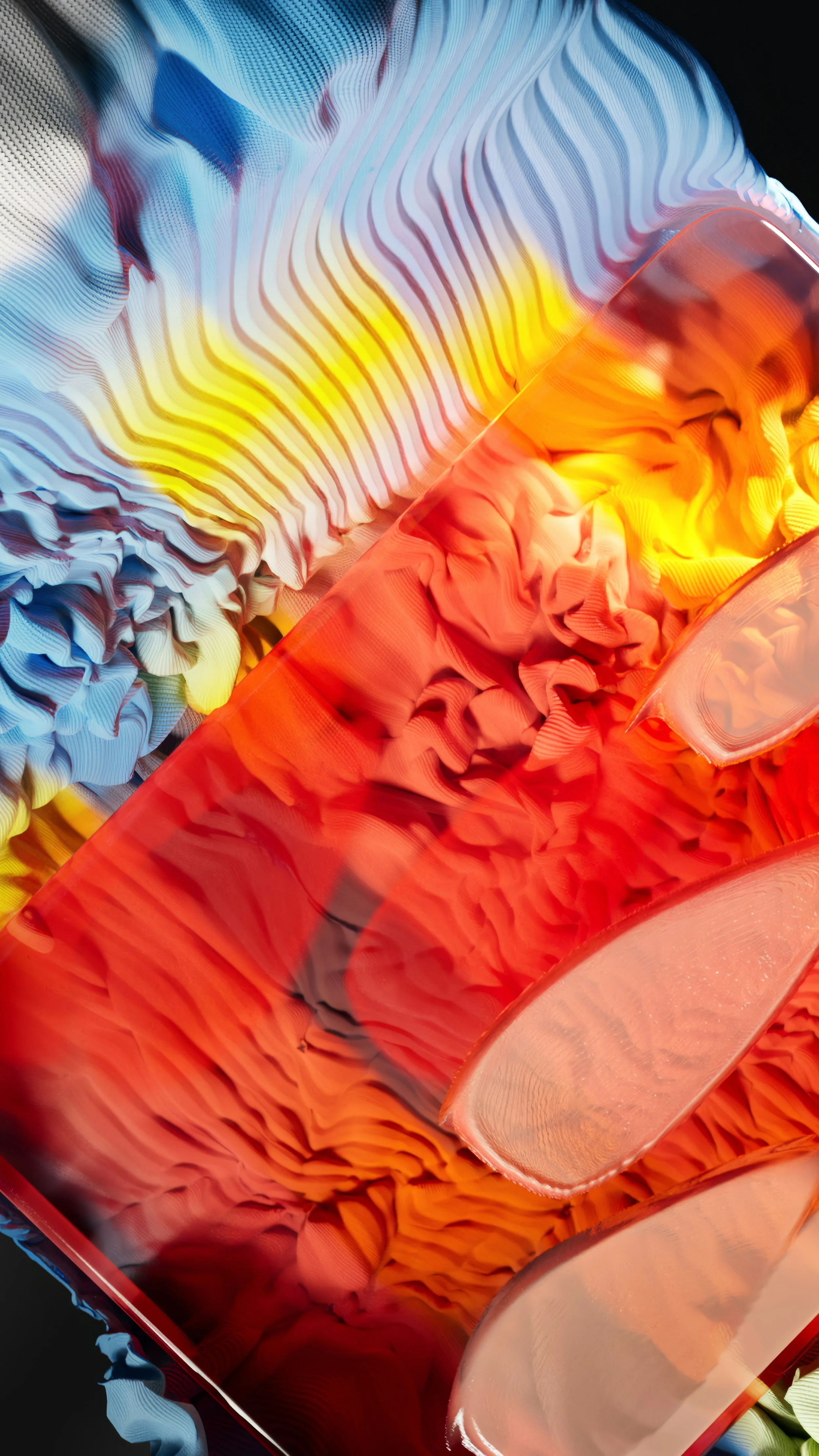 Close-up of colorful glass art with swirling patterns in shades of blue, yellow, orange, and red.