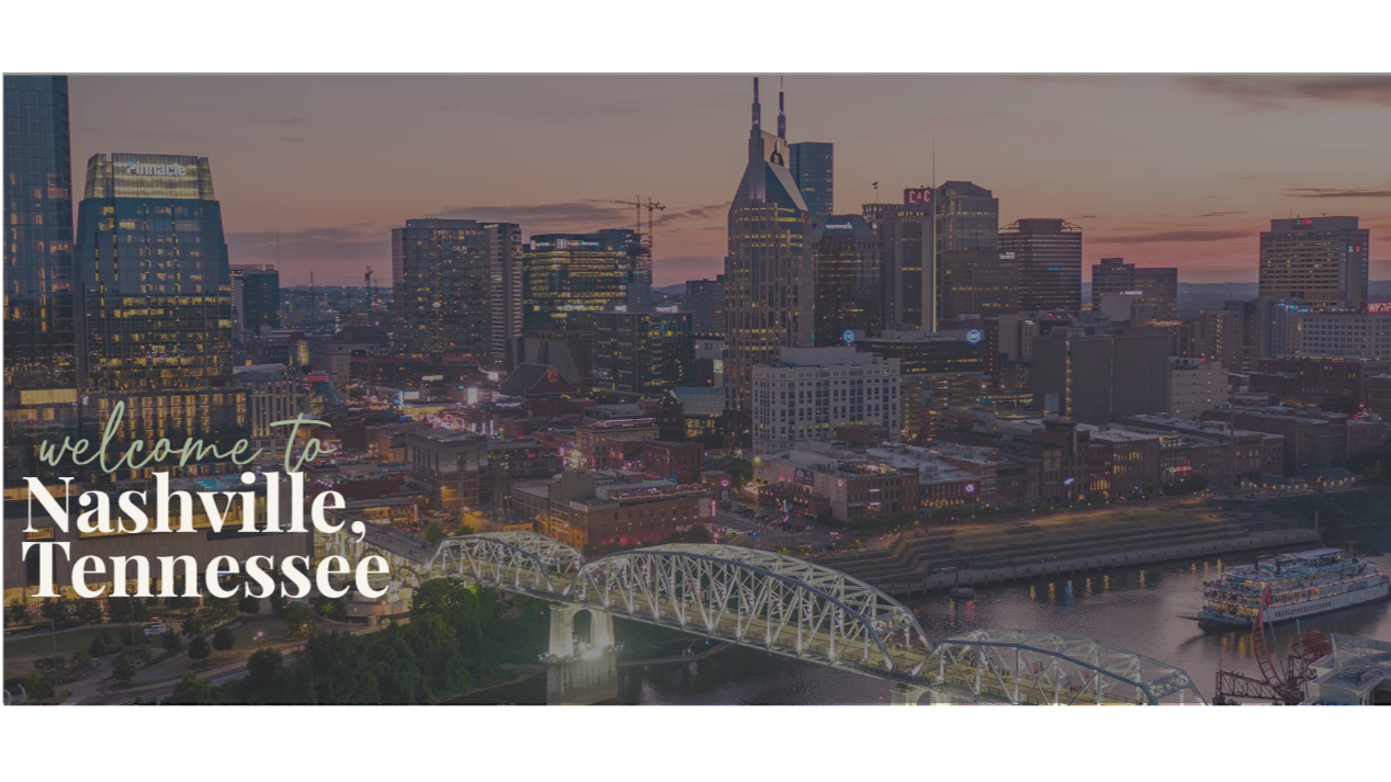 Skyline of Nashville, Tennessee, at sunset with illuminated buildings, a bridge over a river, and a Ferris wheel