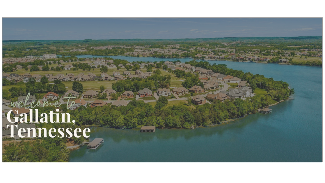 Aerial view of residential neighborhood with houses, trees, and a waterfront in Gallatin, Tennessee, under a partly cloudy sky.