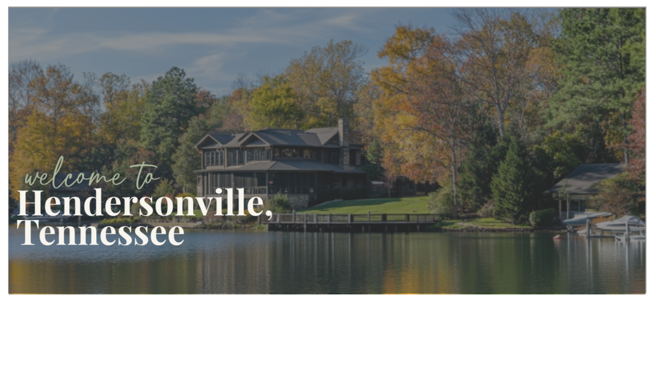 A photo of a large house beside a river with trees and a dock in Hendersonville, Tennessee, during fall with colorful autumn leaves.