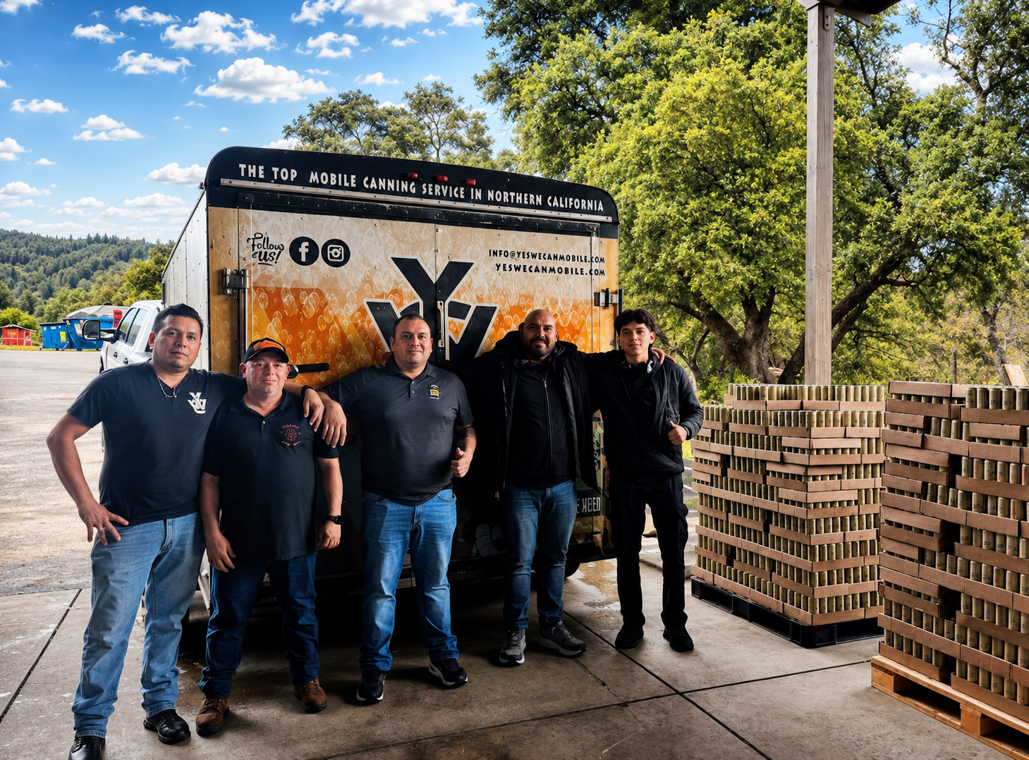 Five men standing in front of a mobile canning service truck with stacks of canned goods at an outdoor location with trees and a blue sky with clouds.