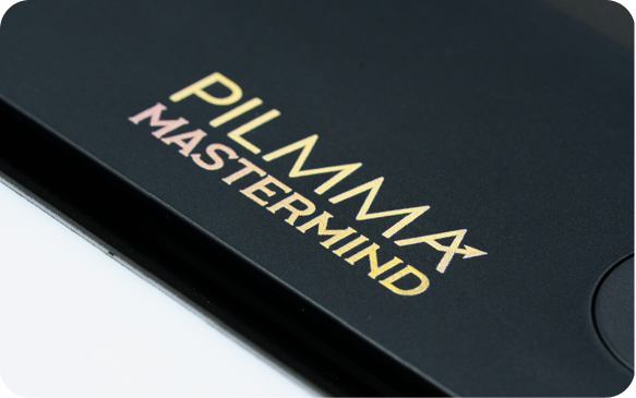 Close-up of a black Amazon Fire tablet showing the 'Pilamma Mastermind' logo on the screen.