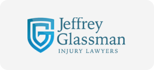 Logo for Jeffrey Glassman Injury Lawyers with a stylized shield and the firm name