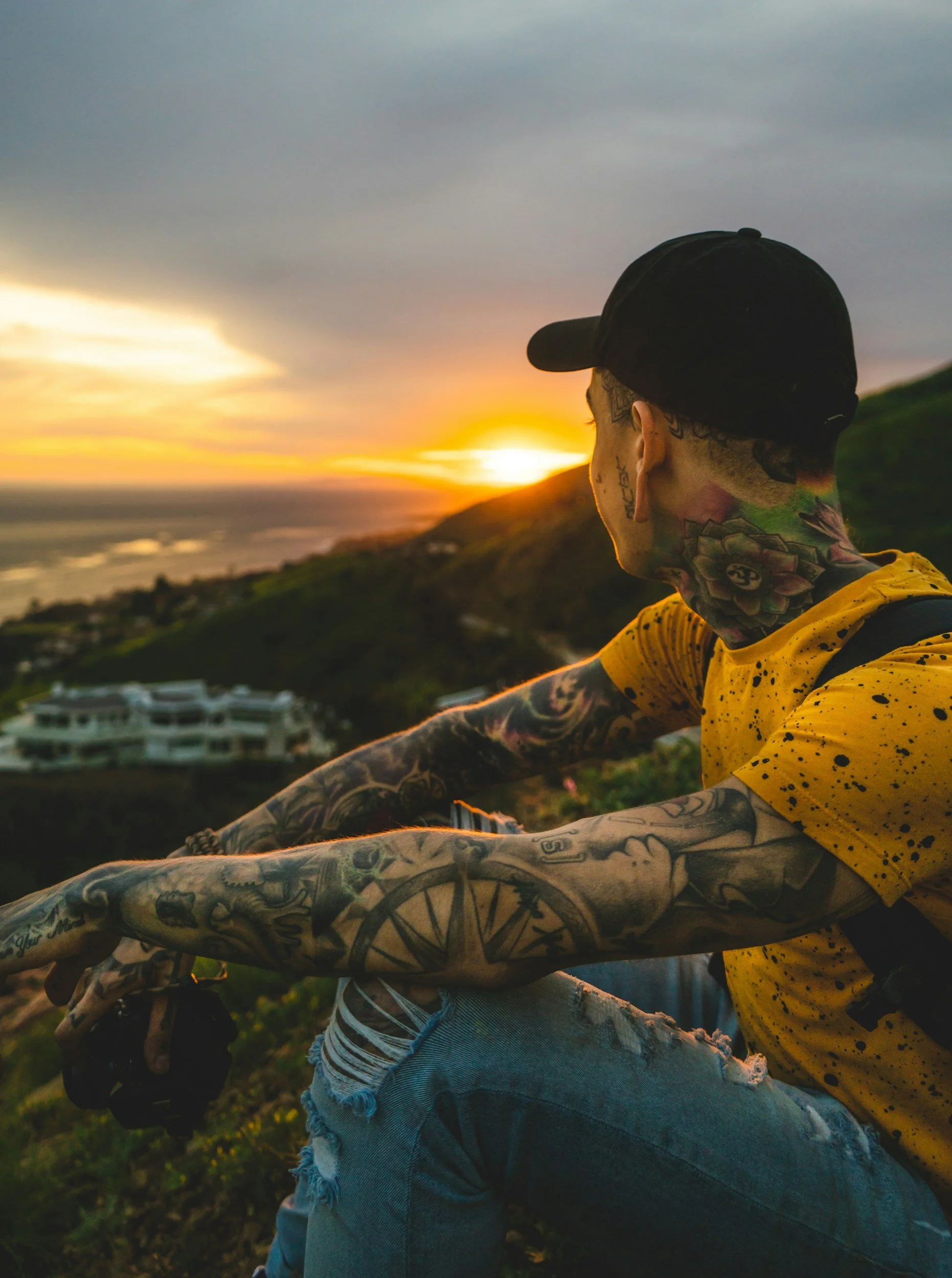 Person overlooking the ocean at sunset, representing reflection, healing, and recovery.