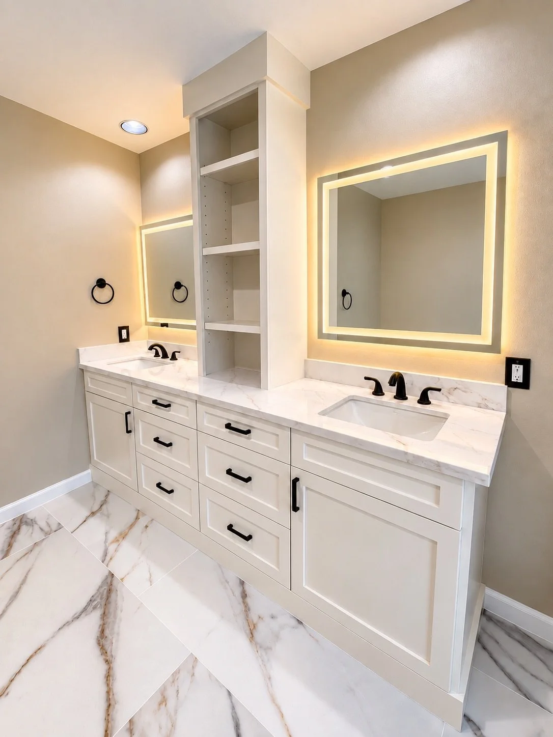 Modern bathroom vanity with two sinks, black fixtures, illuminated mirrors, and marble countertops and flooring.