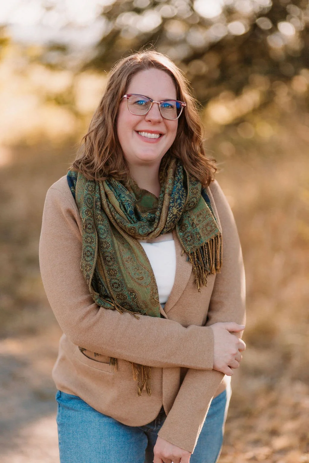 Ashley Sullivan, LCSW, smiling outdoors, available for a free consultation