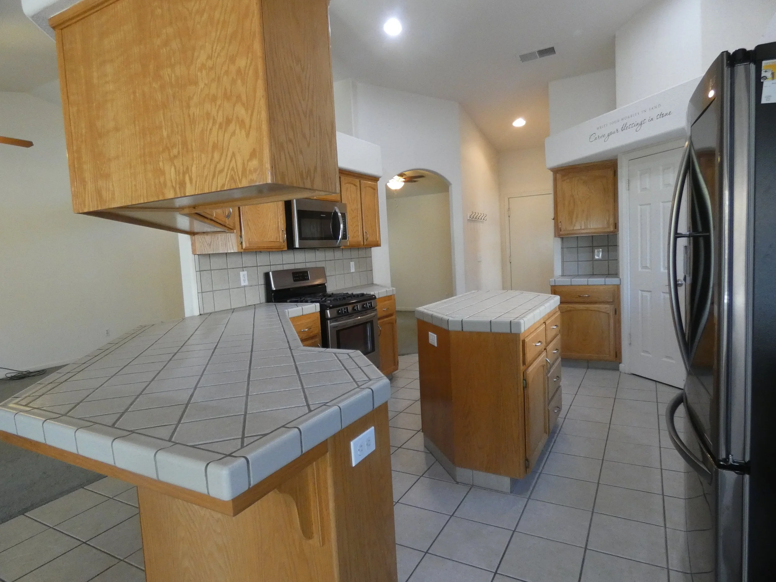 A uniquely designed kitchen with center island and plenty of cabinet space.