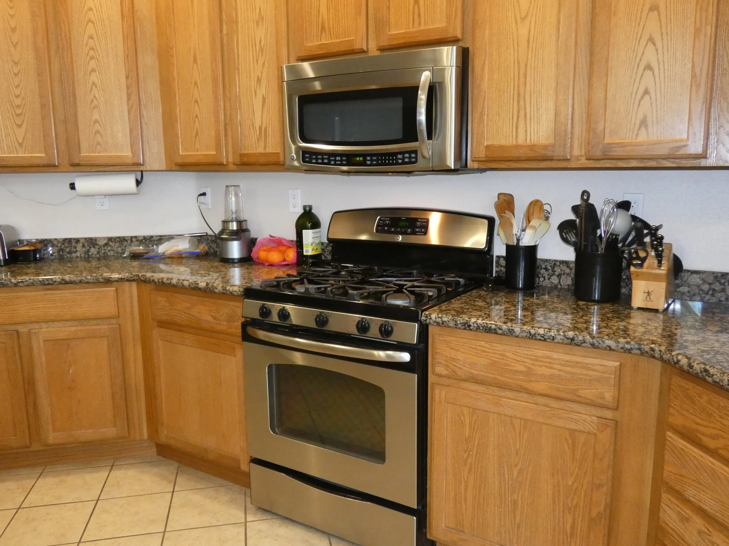 A kitchen with granite counters and stainless steel appliances.