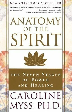 Book cover of 'Anatomy of the Spirit' by Caroline Myss, Ph.D., with subtitle 'The Seven Stages of Power and Healing' and a gold flower illustration.