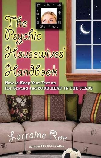 Book cover titled 'The Psychic Housewives' Handbook' by Lorraine R. Features a living room with a pink and green striped wall, a beige couch with patterned pillows, a framed photo of a woman's eye on the wall, a window showing a nighttime sky with a crescent moon and stars, and a soccer ball on the floor.