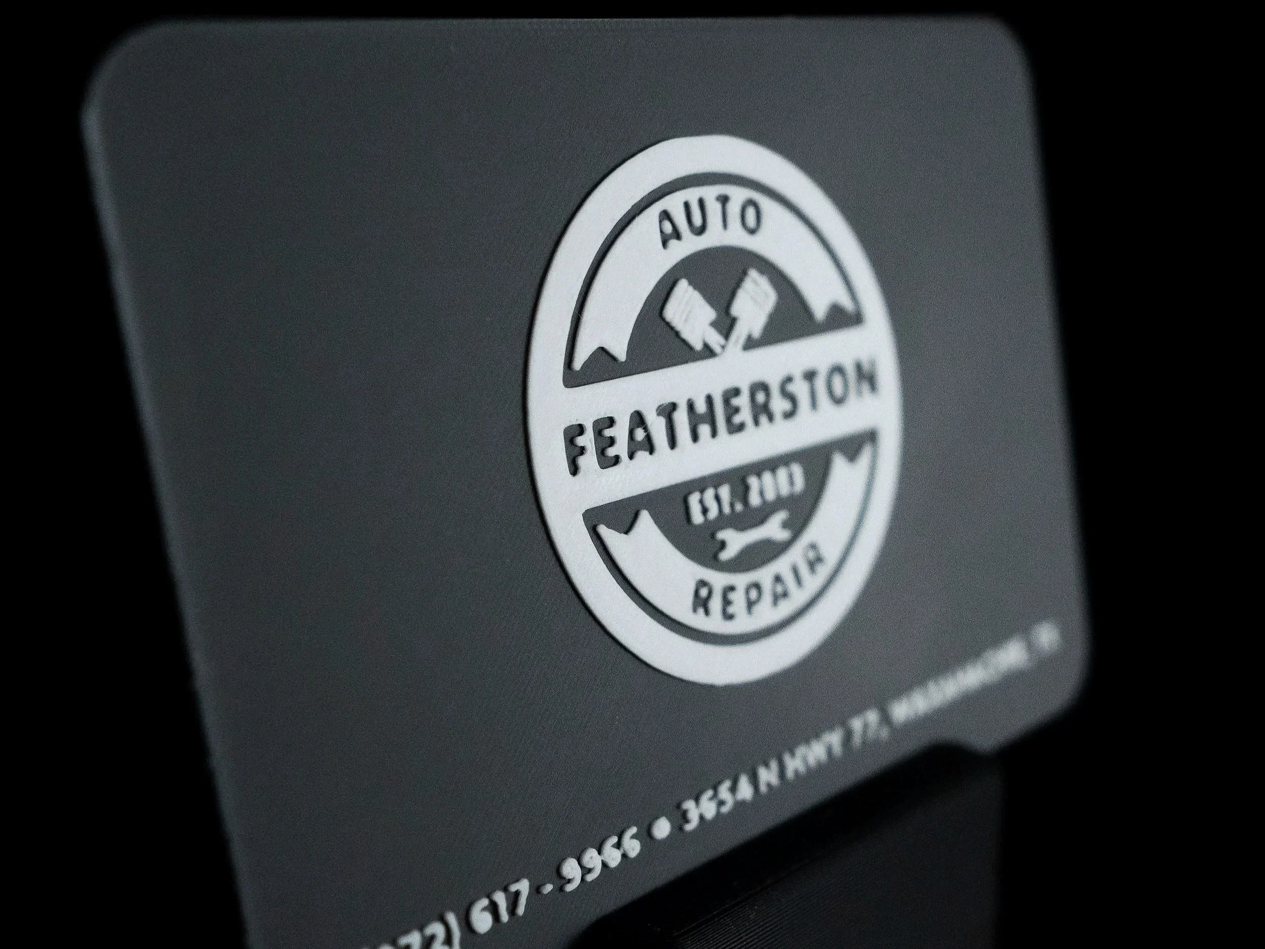 Close-up of custom branded 3D printed NFC business card in grey and white. 
