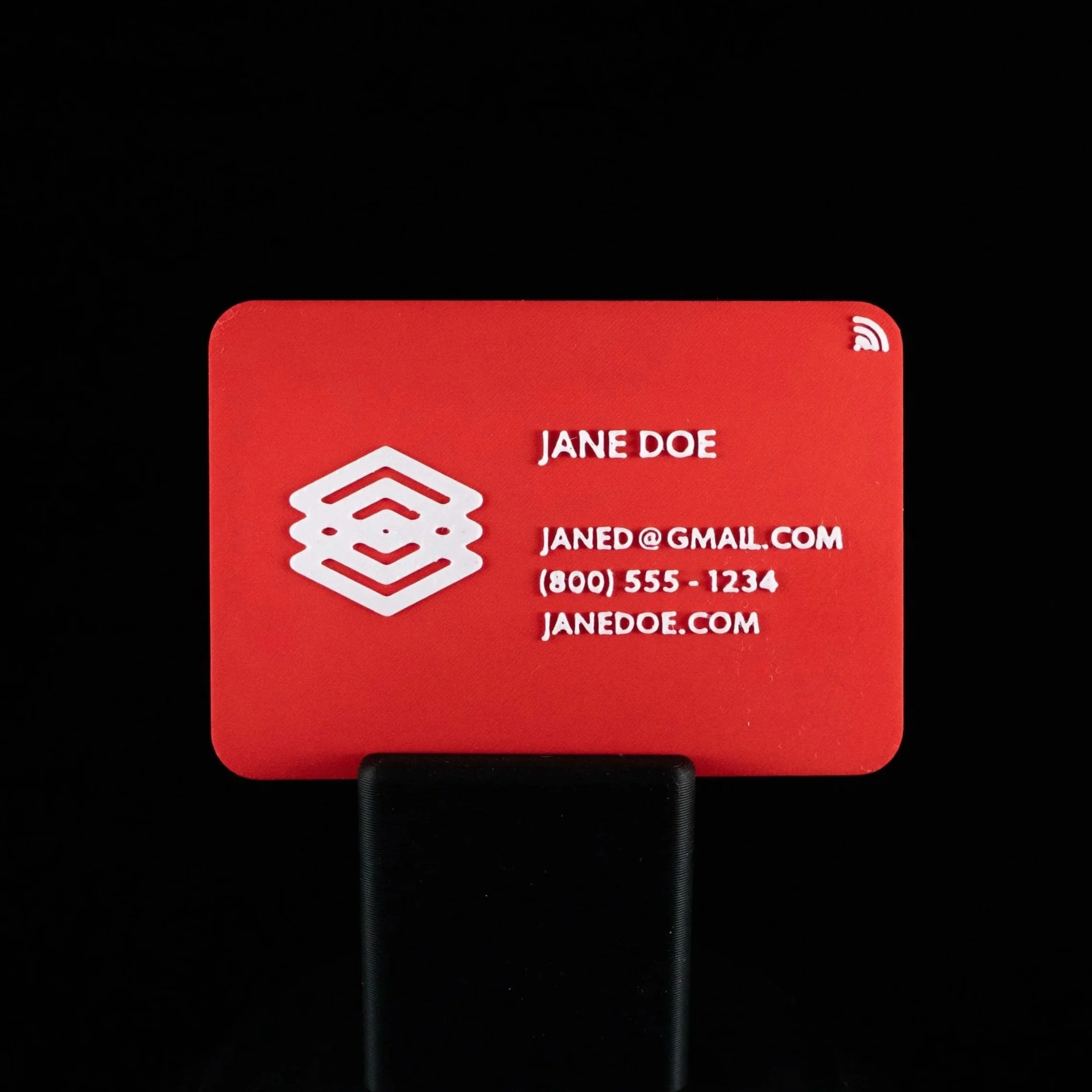 A 2 color 3D printed business card with an red and white color scheme and an NFC logo. 