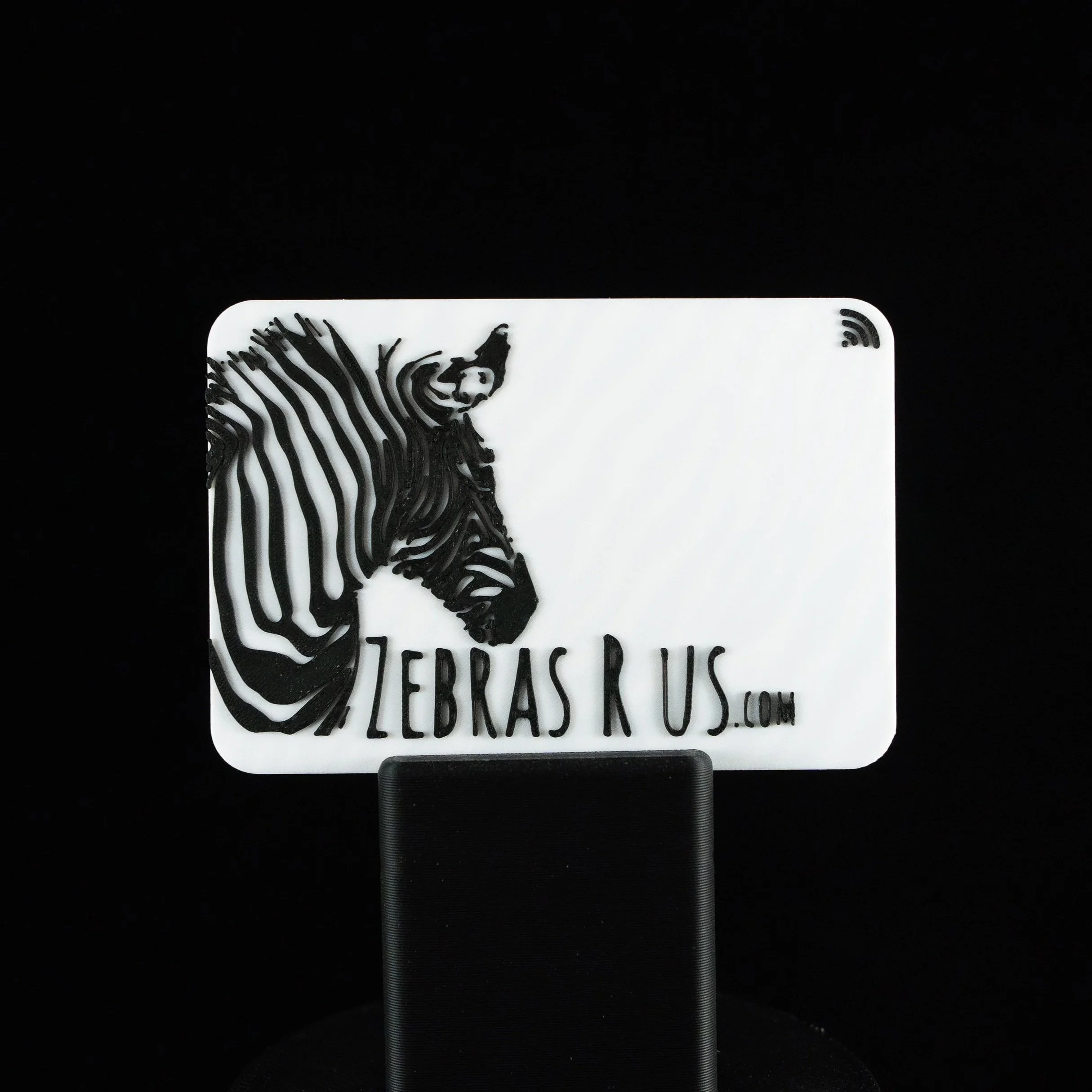  3d printed business card with black and white zebra design and text.