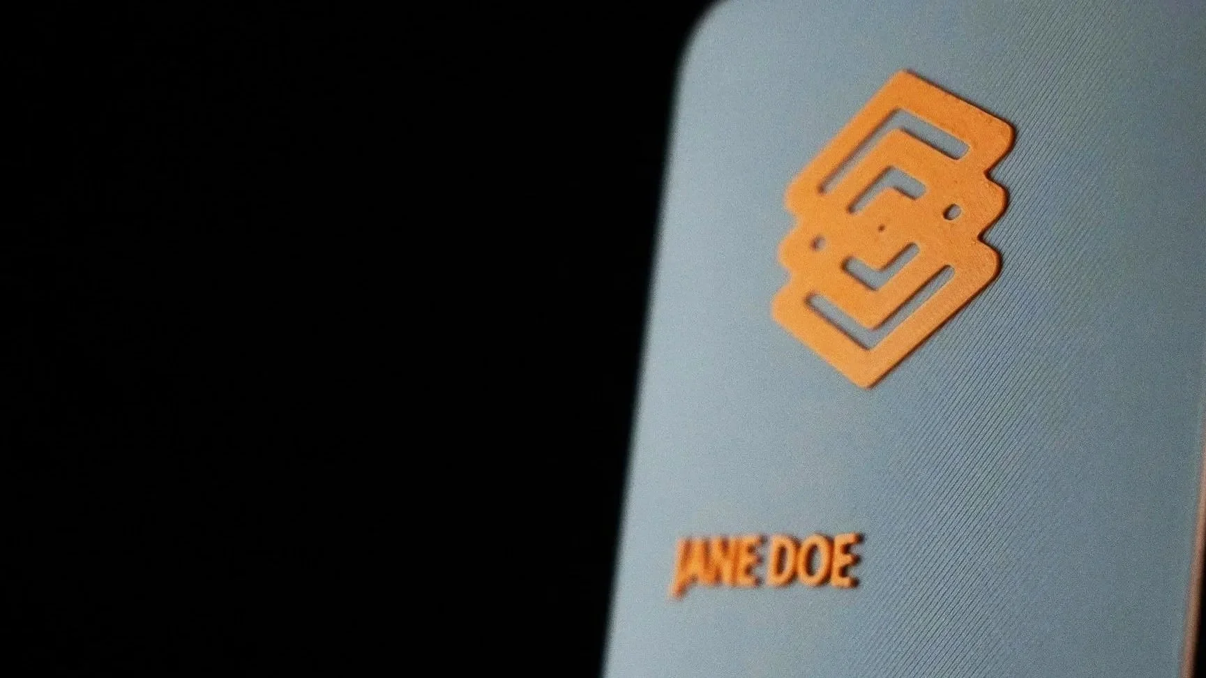 A 3D printed business card with an orange and grey color scheme.