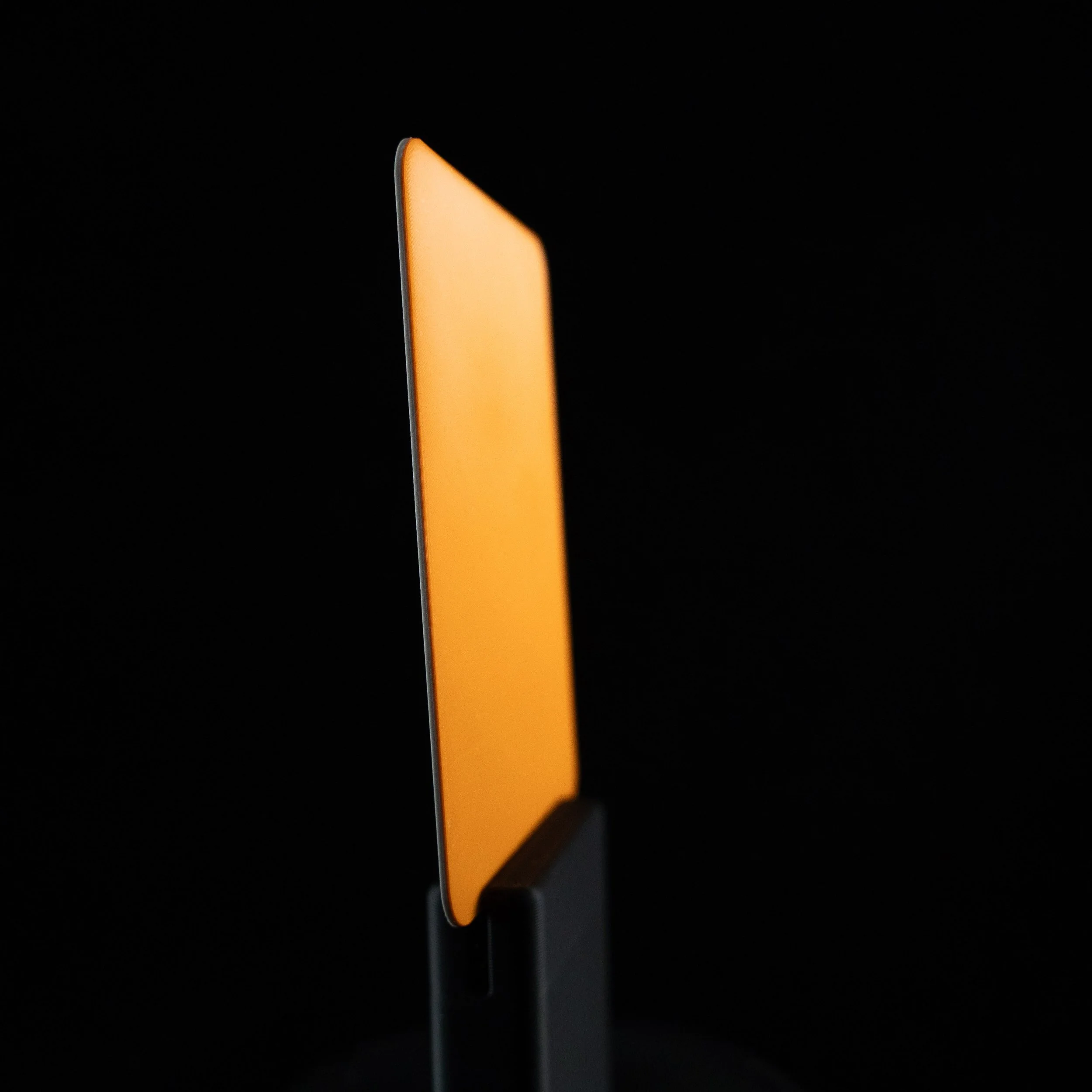 Close-up of a orange backer for a 3D-printed NFC business card. 