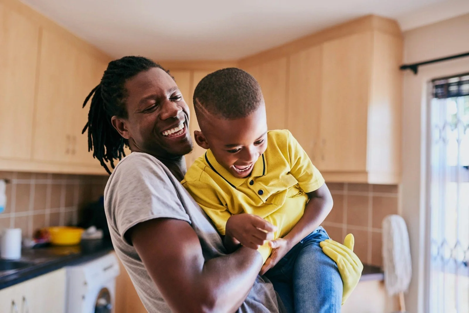 Father hugging his son at home