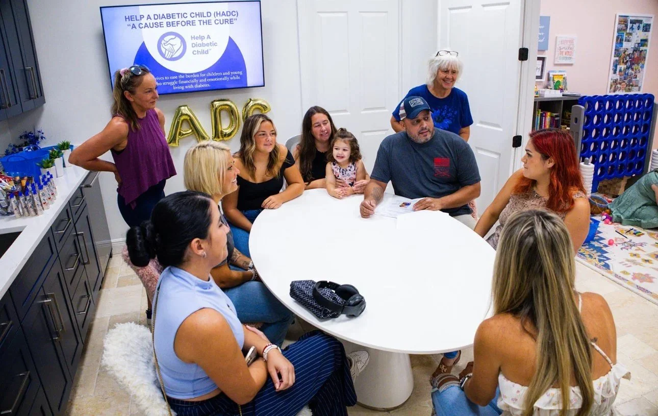 People gathered around a table at an HADC event