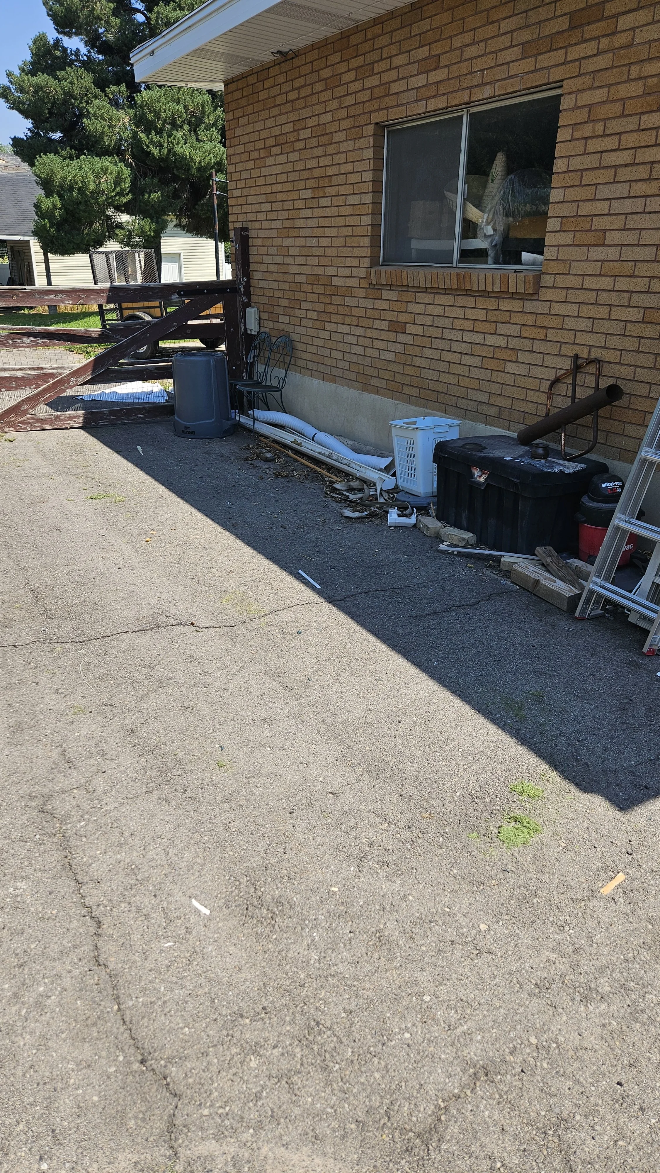 Junk has been cleaned up in a driveway.