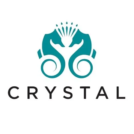A logo featuring two stylized seahorses facing each other with a crown-like design above, and the word "CRYSTAL" below.