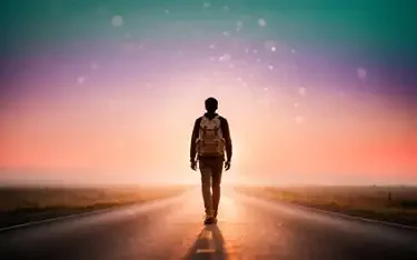 Person walking on a road at sunset with a colorful sky and stars.