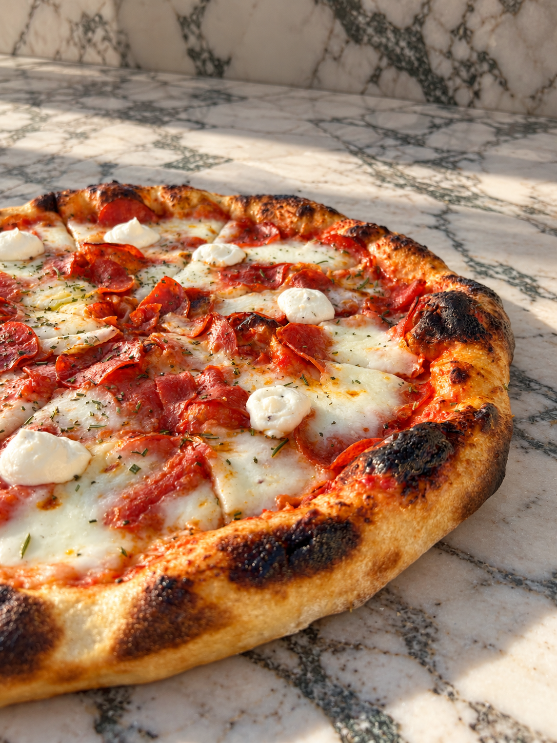 Sunlit Pepperoni Pizza on Marble.png