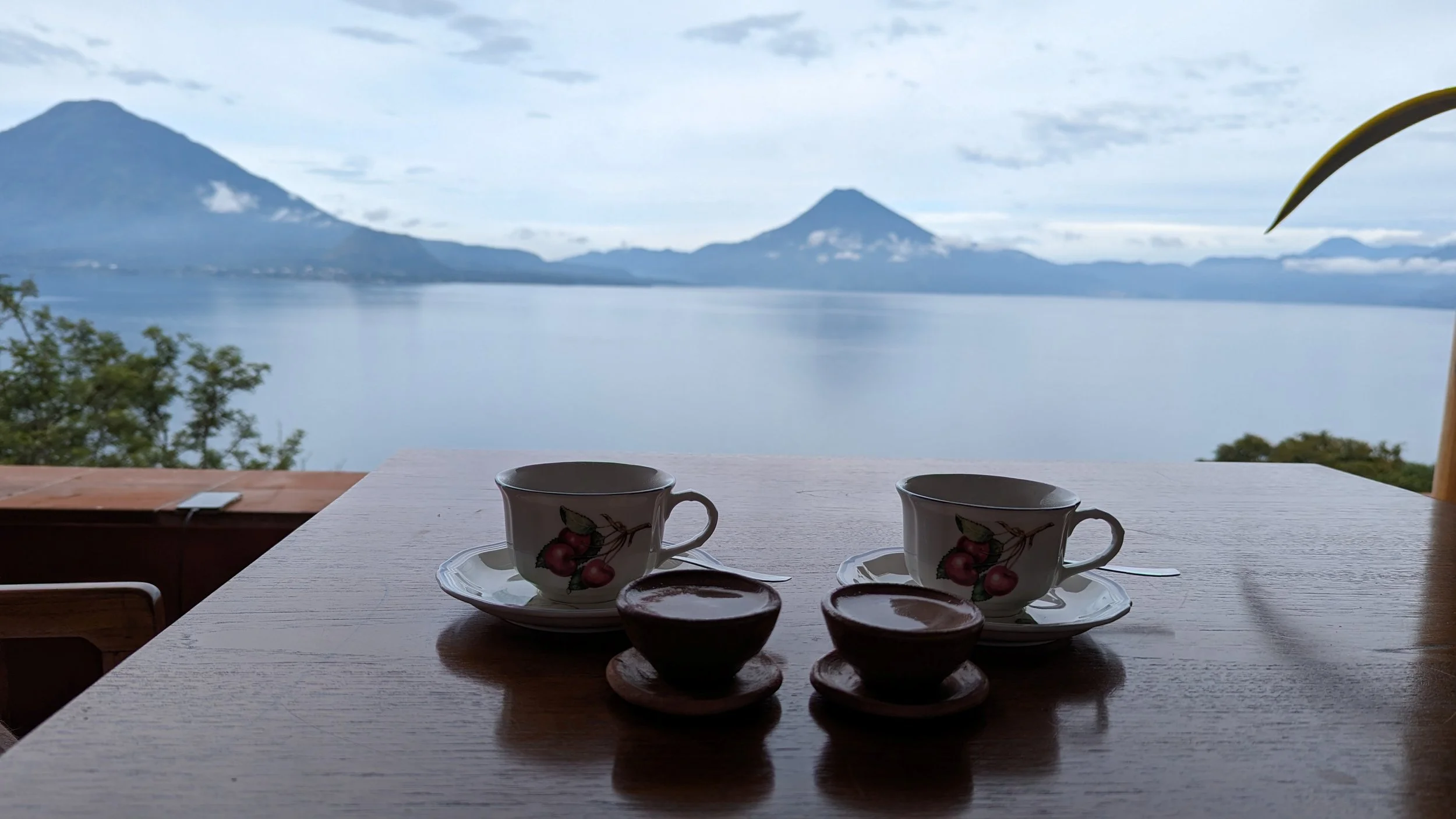 Coffee overlooking Lake Atitlán and the surrounding volcanoes in Guatemala