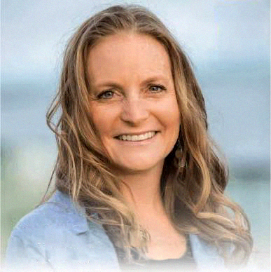 Smiling woman with wavy hair outdoors during daytime, background of sky and ocean