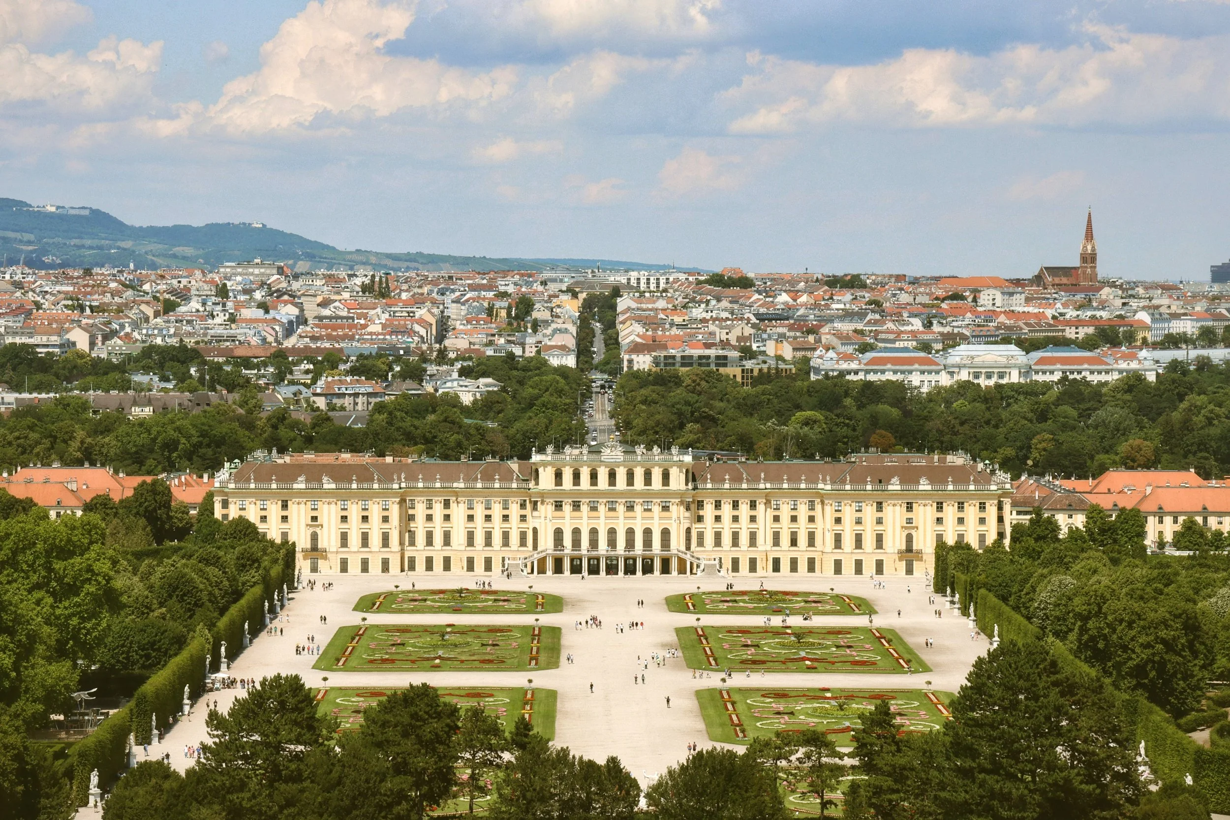 Schönbrunn Palace and its formal gardens seen from above, with the city skyline behind, Vienna.