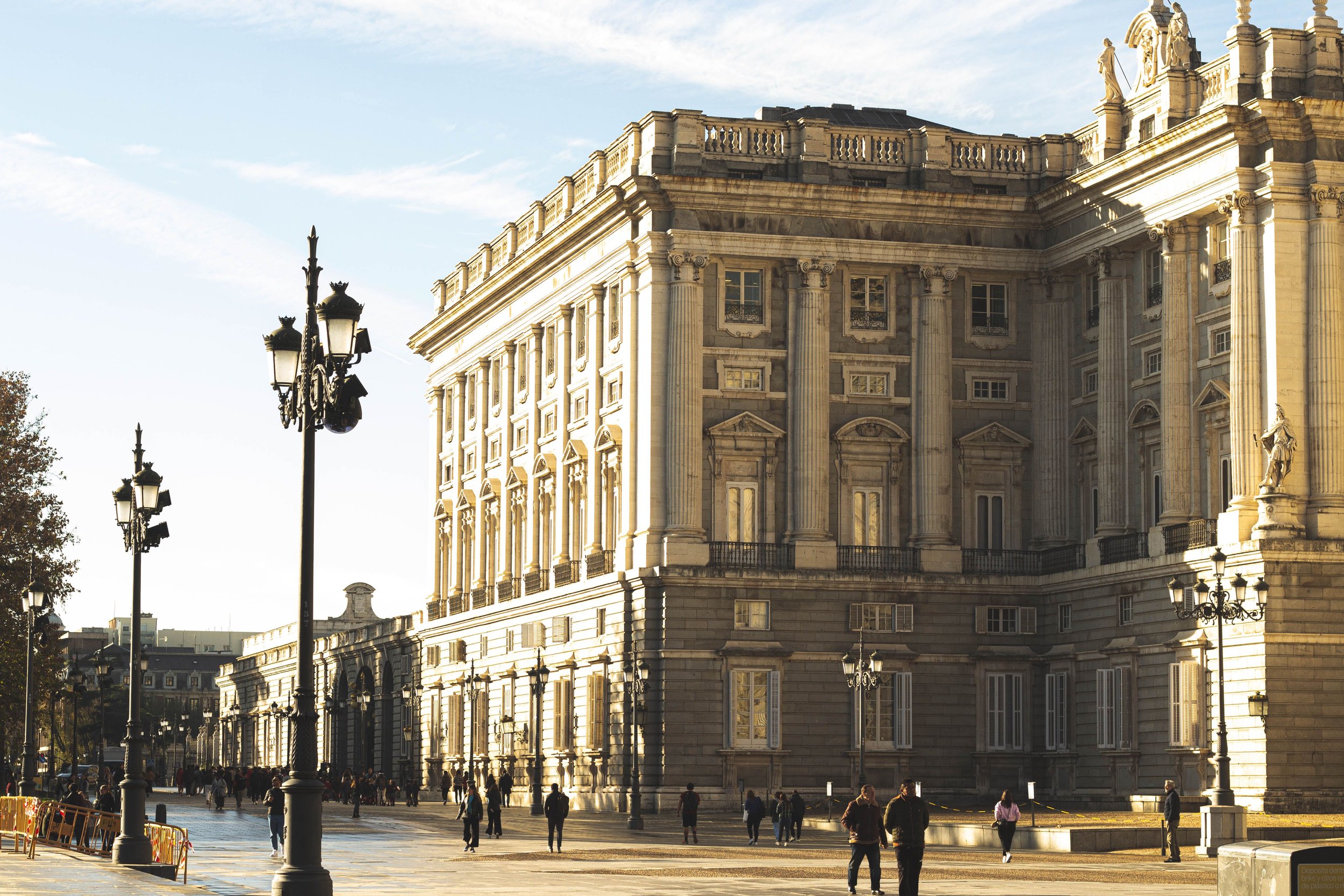 Royal Palace facade with rooftop statues and tall columns, Madrid