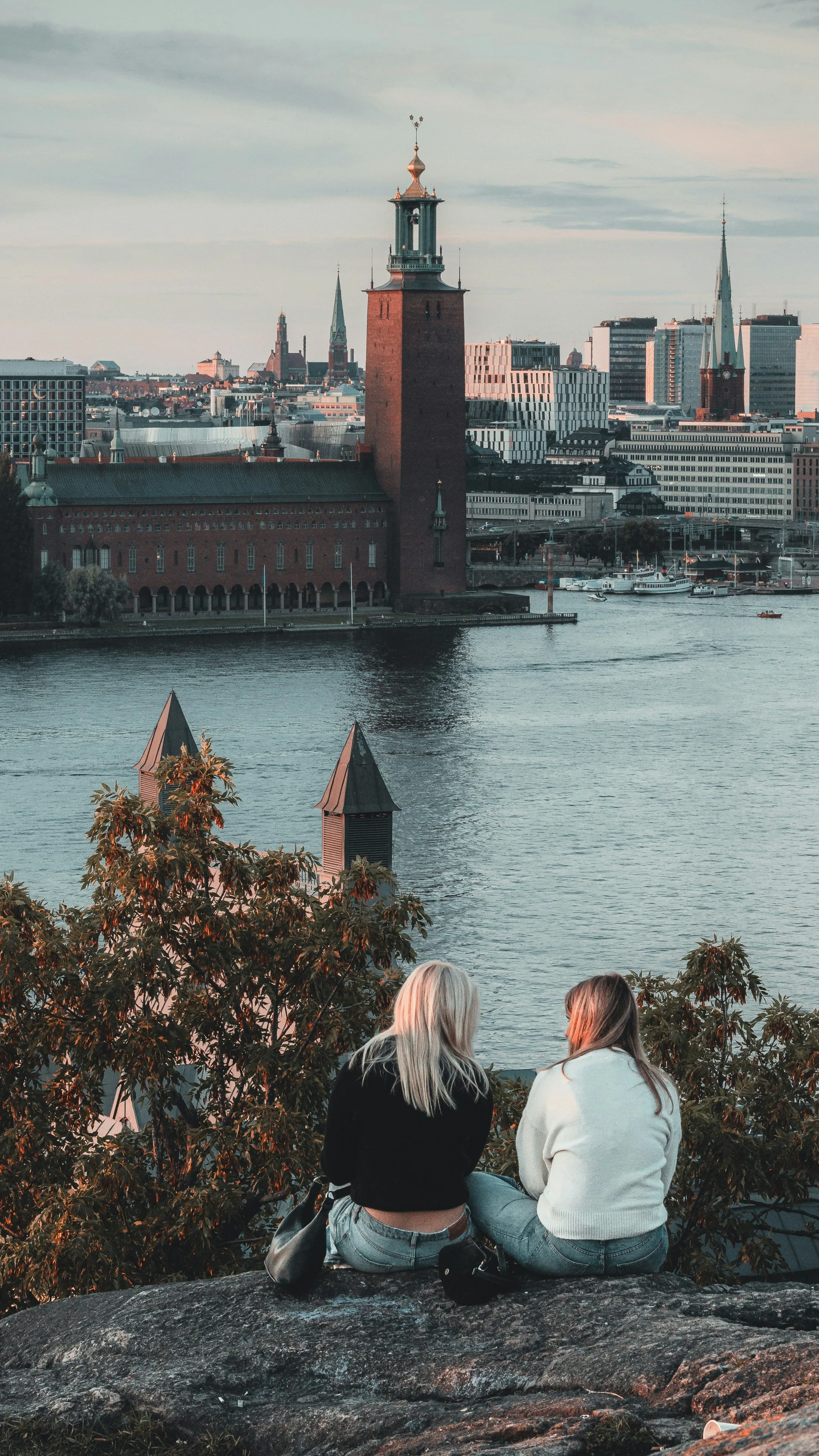 City Hall tower rising above the waterfront through autumn foliage, Stockholm