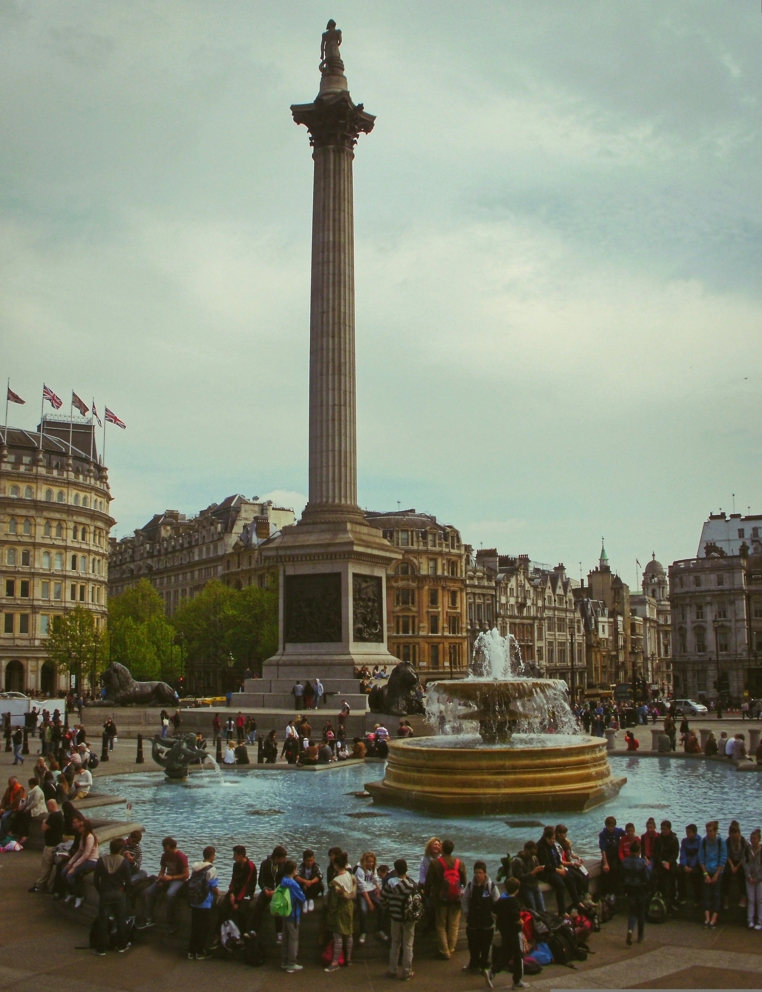 Nelson's Column rising above the fountains and crowds in Trafalgar Square, London