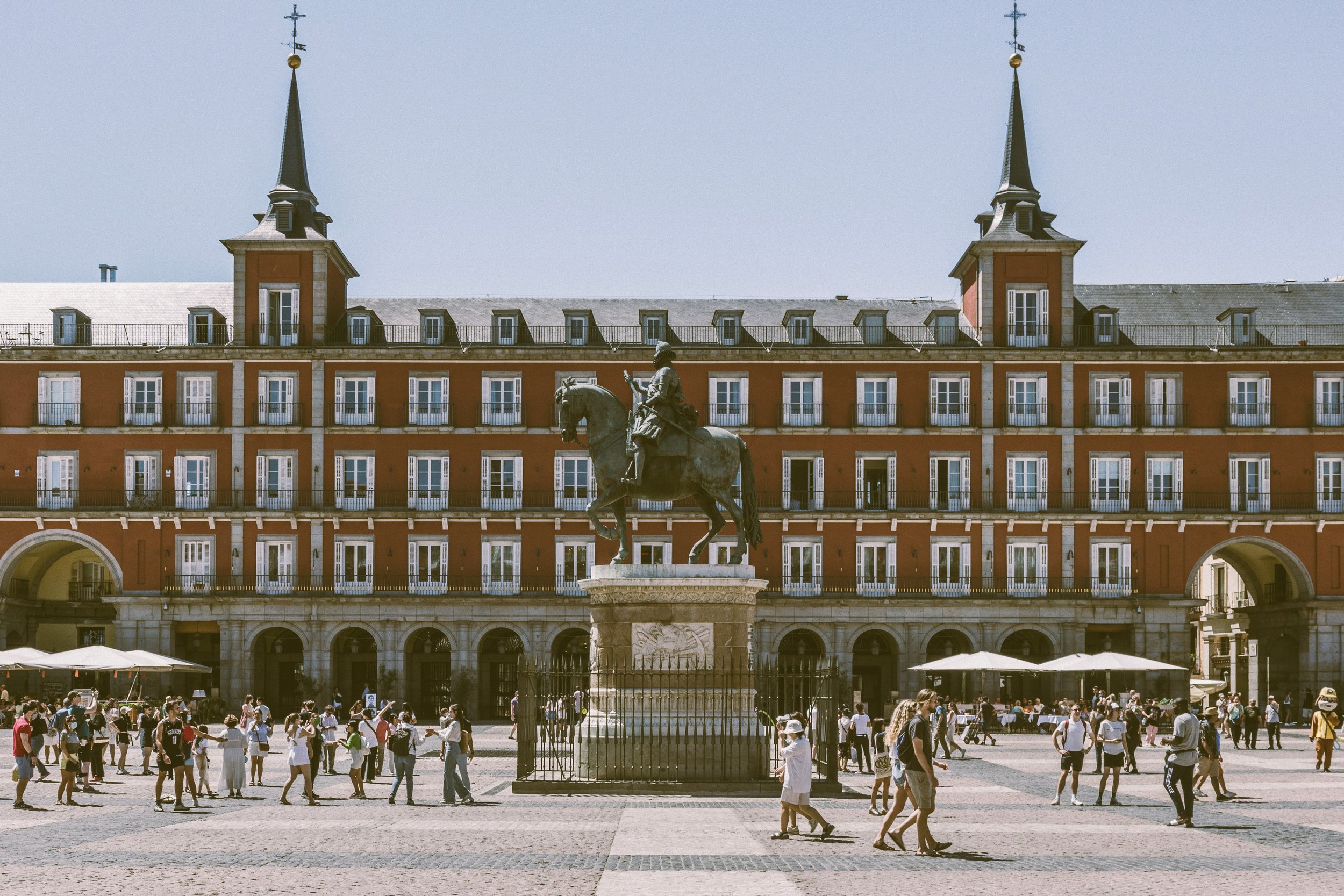 Plaza Mayor in Madrid with its arcaded facades and statue