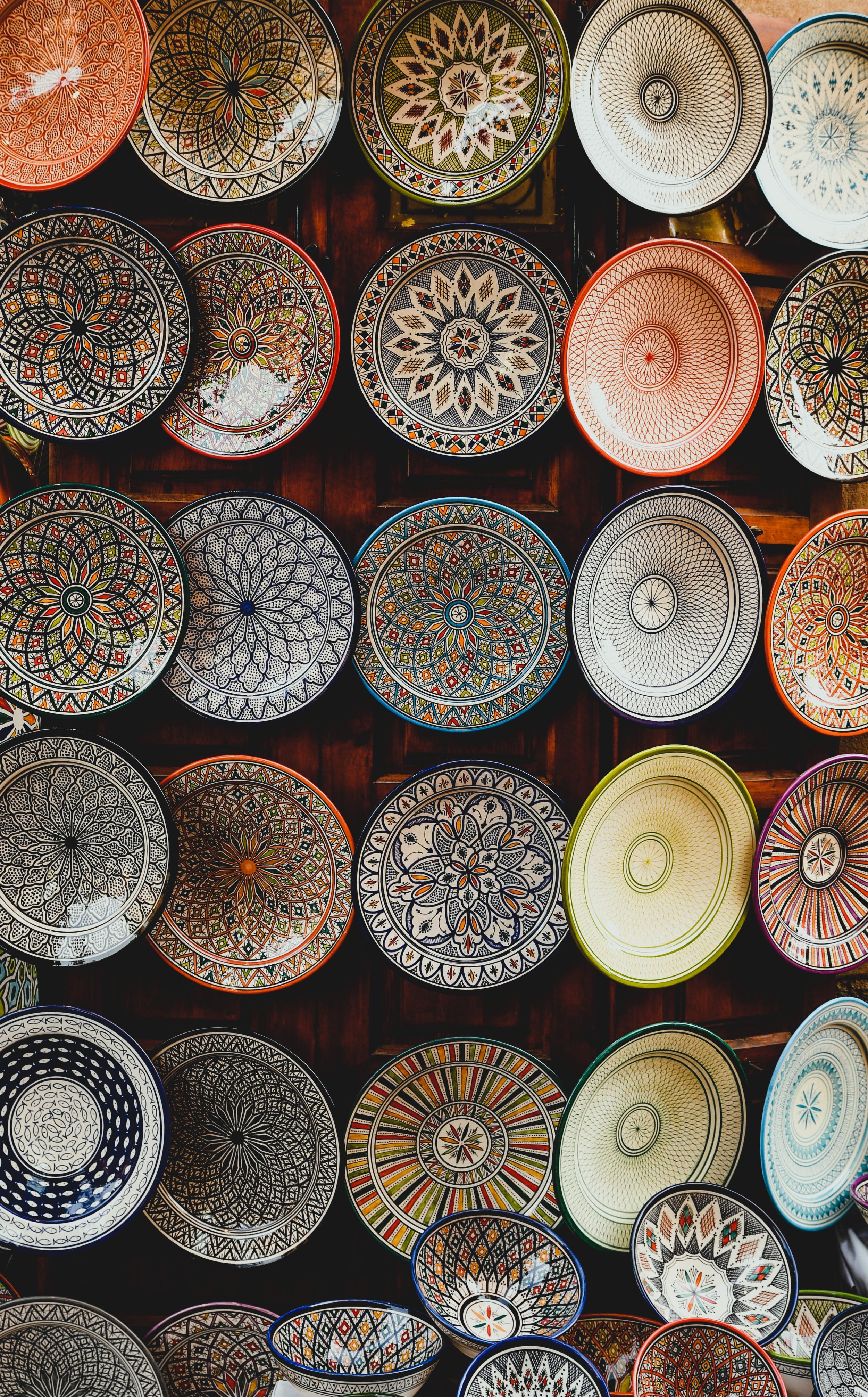 Stacks of hand-painted ceramic plates and bowls displayed at a souk stall, Marrakech.