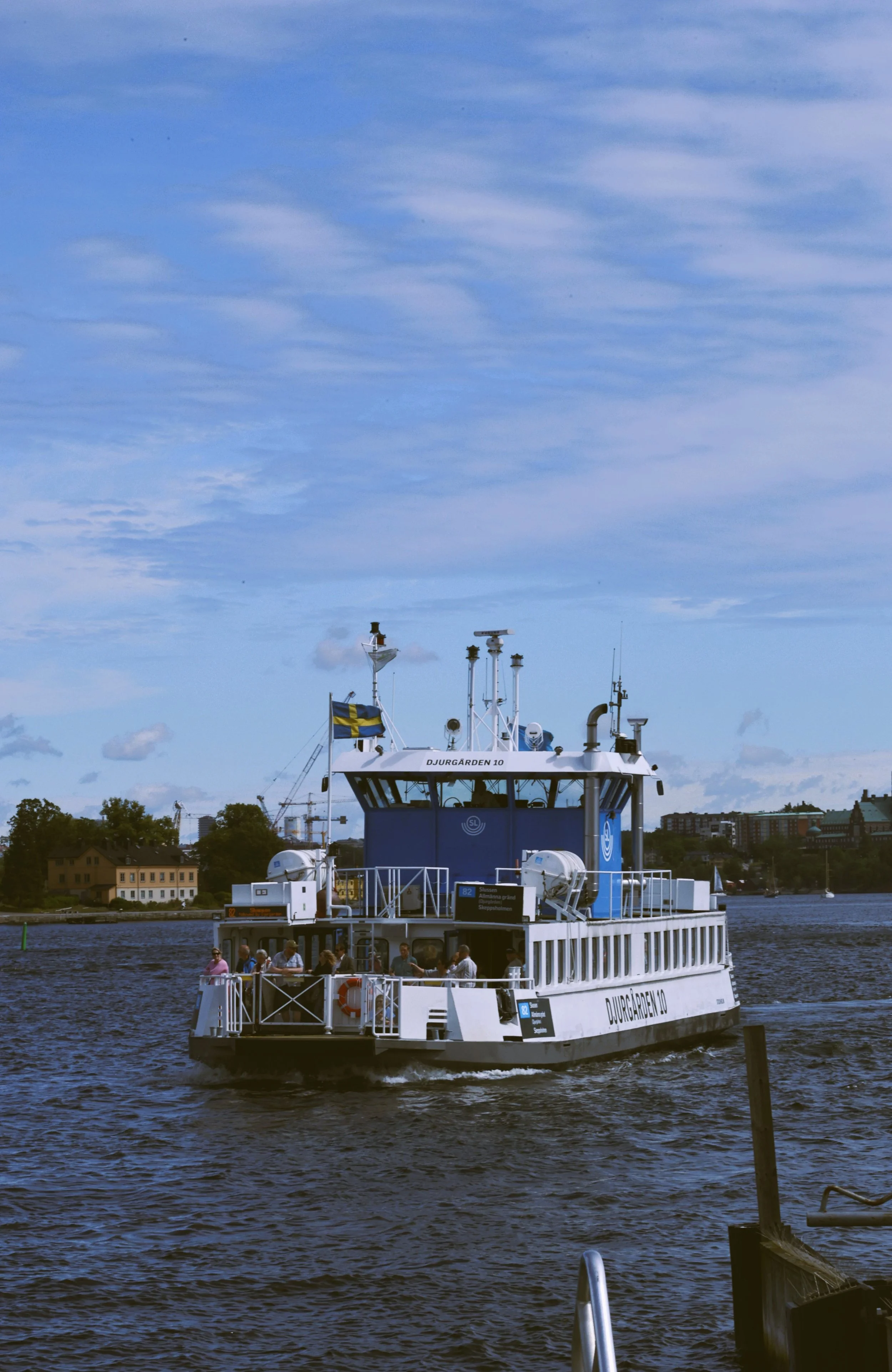 White passenger ferry crossing calm water in the Stockholm archipelago