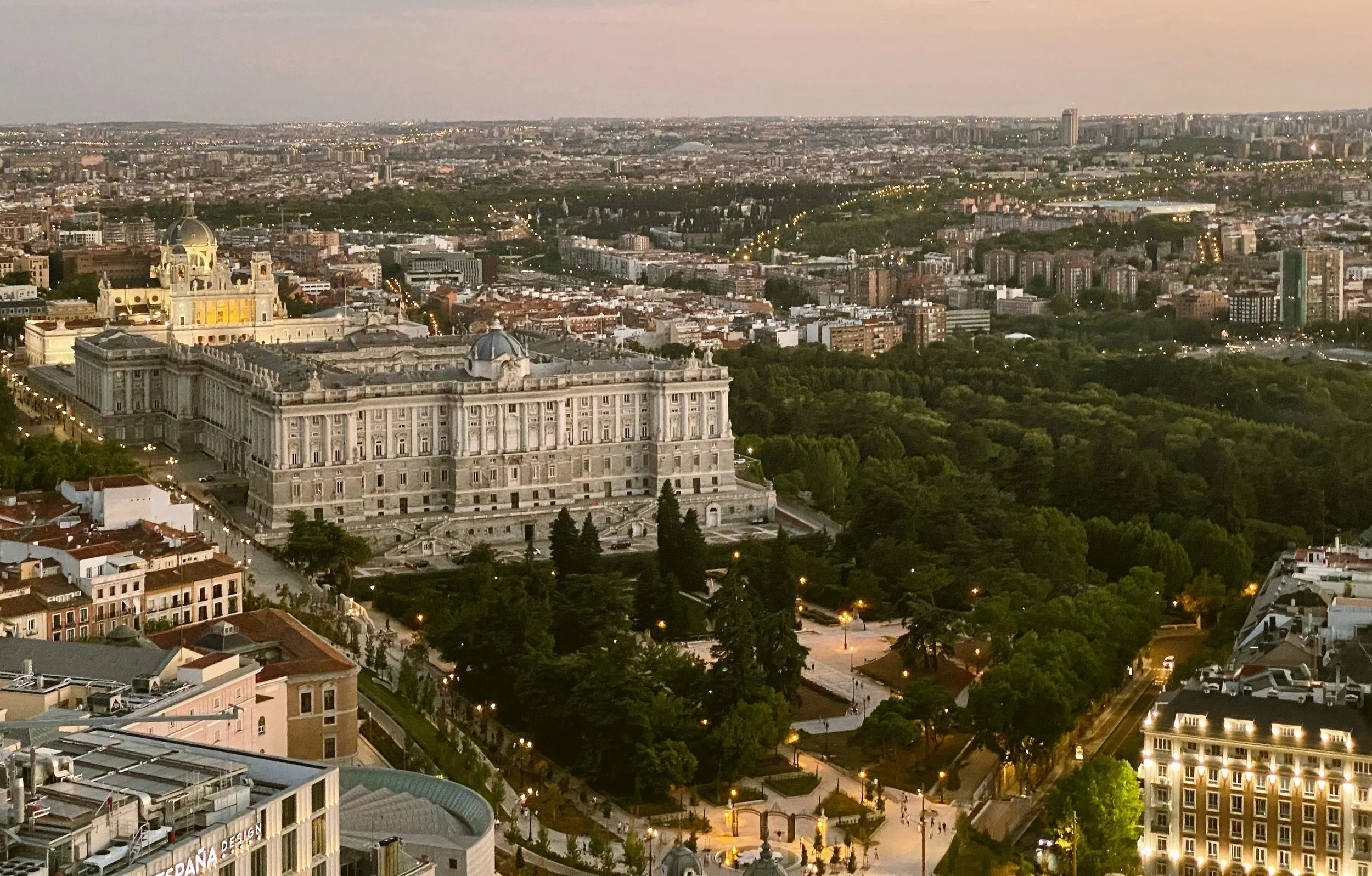 Aerial view of the Royal Palace and Almudena Cathedral above the Sabatini Gardens at dusk, Madrid