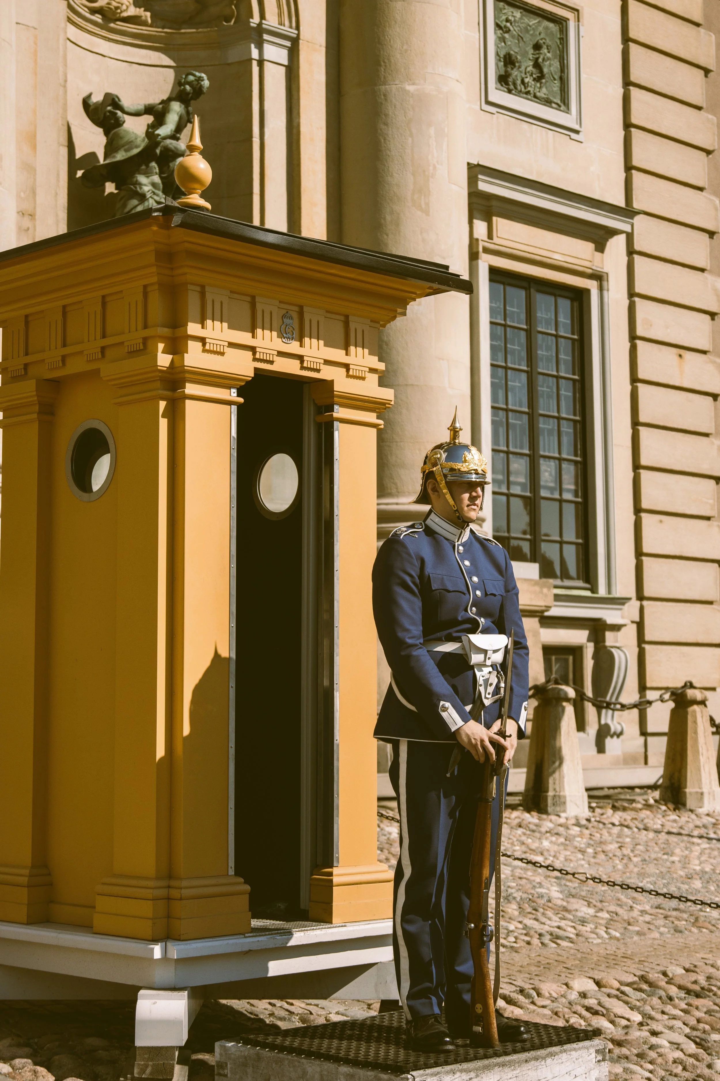 Royal guard beside a yellow sentry box at the Royal Palace, Stockholm