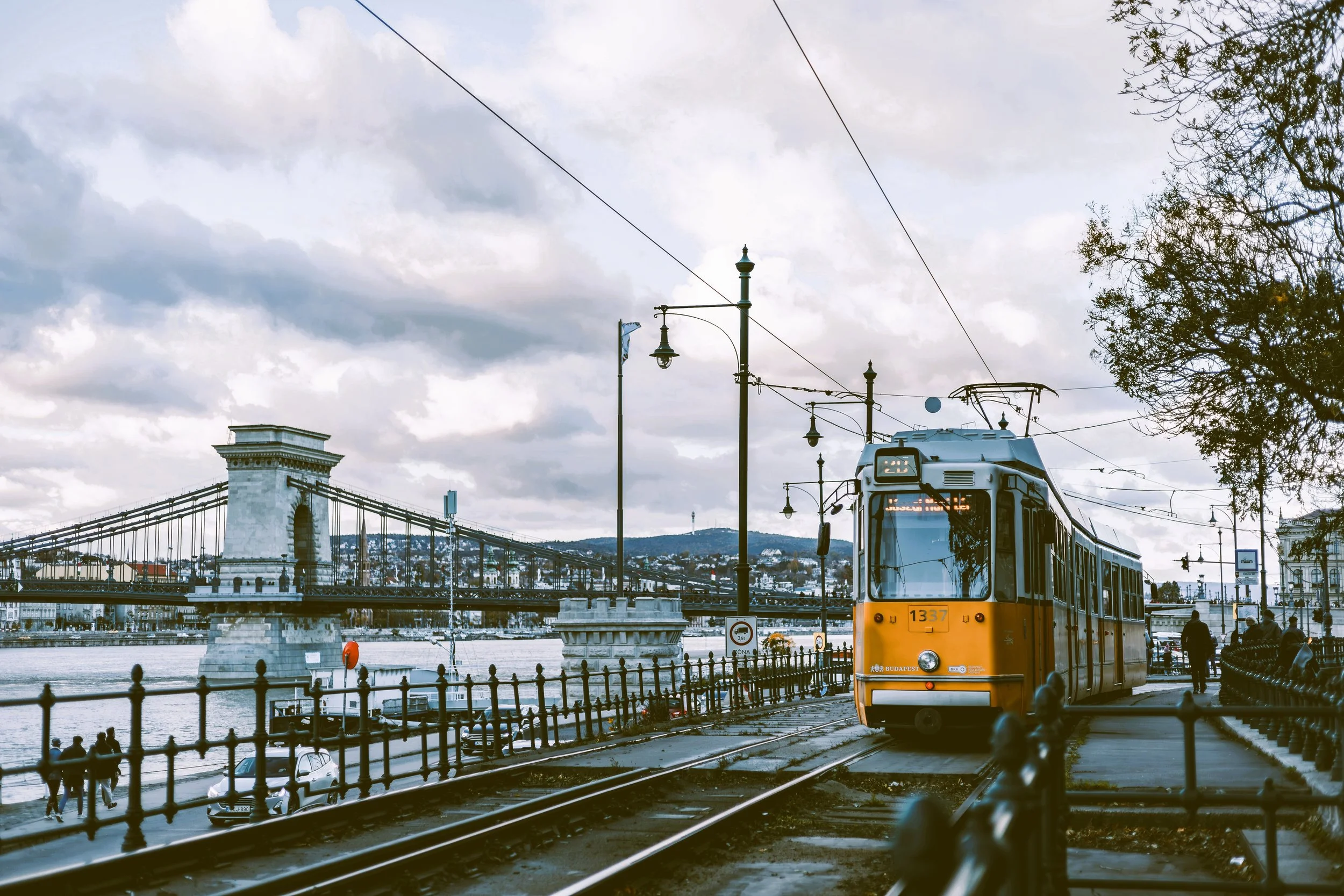 Famous yellow tram 2 on the Danube embankment, Chain Bridge behind, Budapest