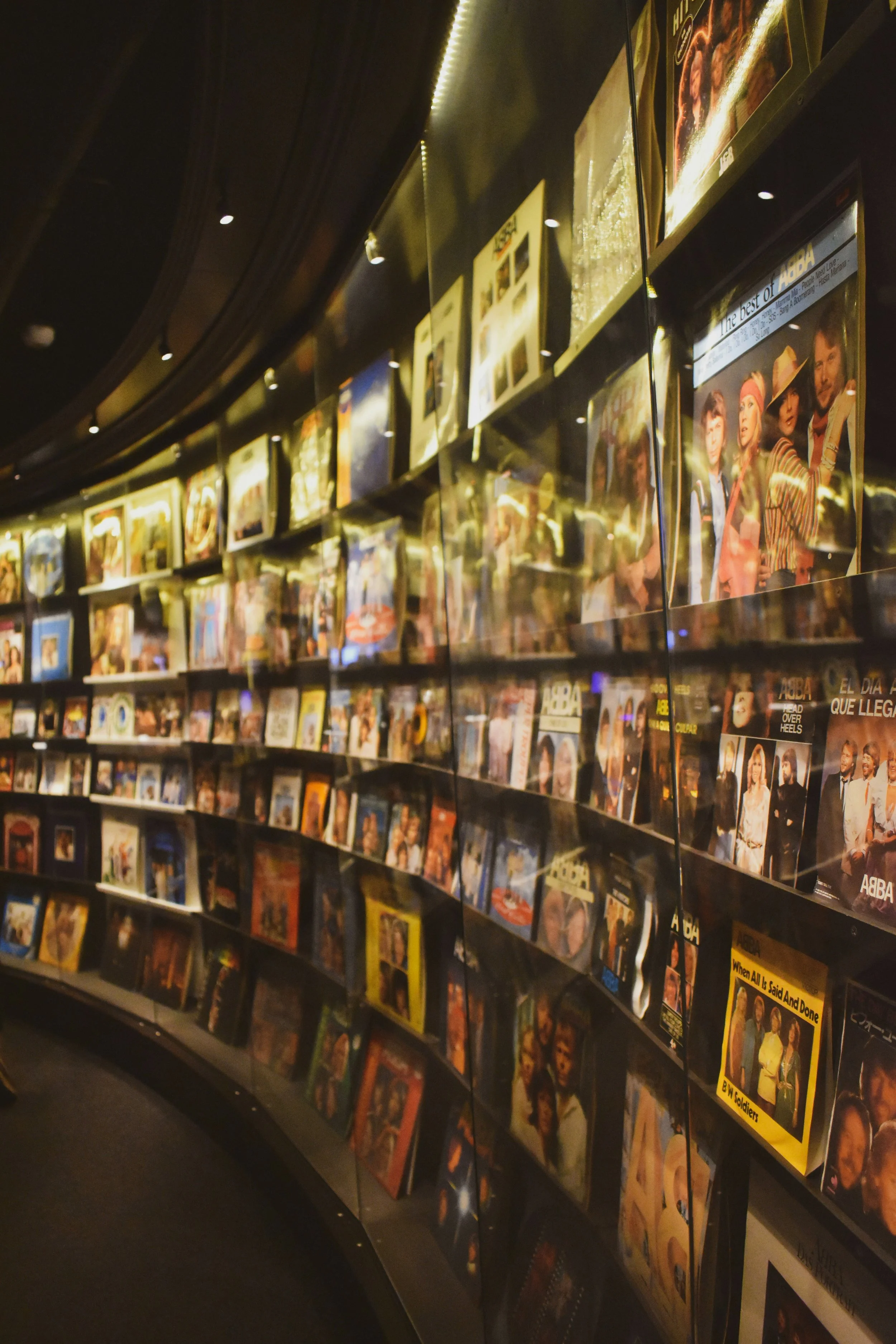 Curved shelves filled with books and magazines inside the ABBA Museum on Djurgården, Stockholm